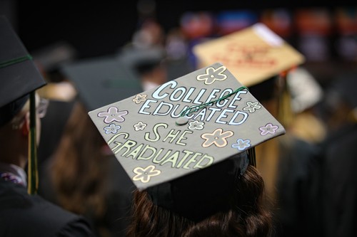 Graduation cap reads, "College educated, she graduated"