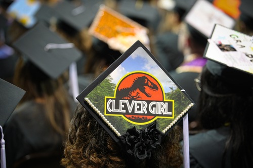 Graduation cap reads, "Clever Girl" with a Jurassic Park logo
