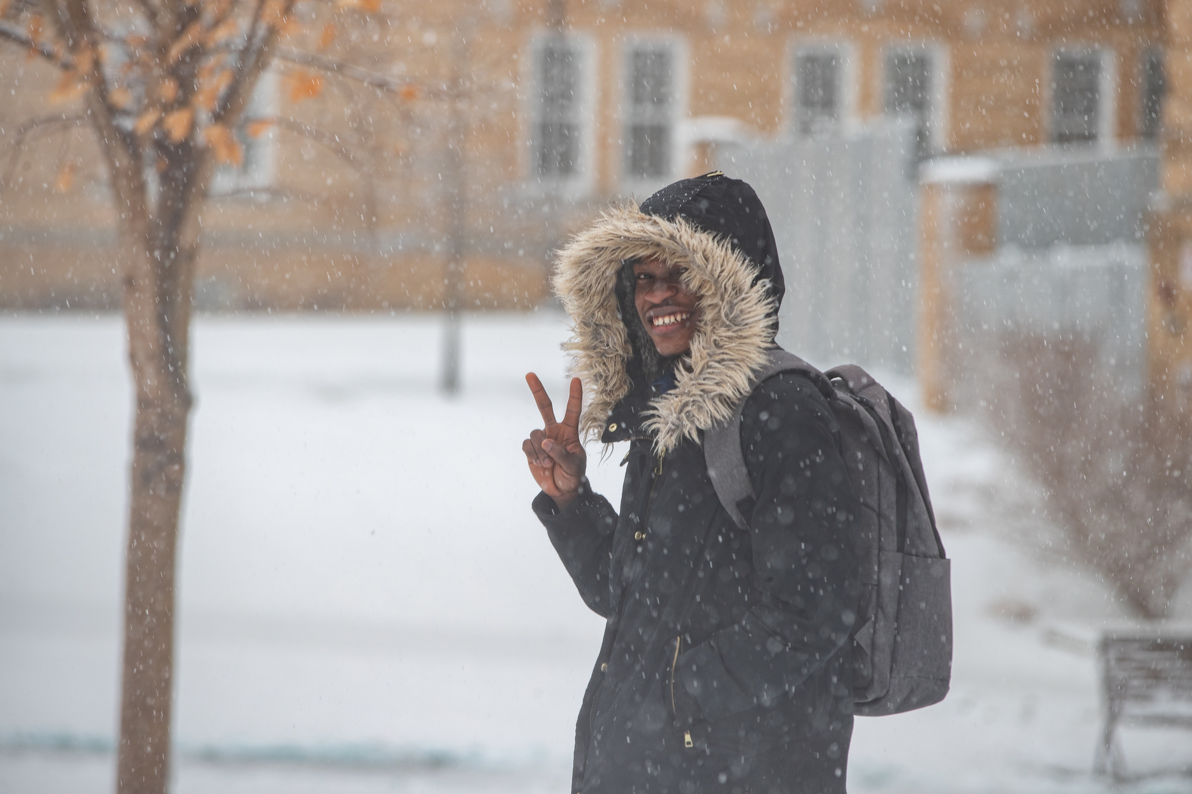 A student gives a peace sign