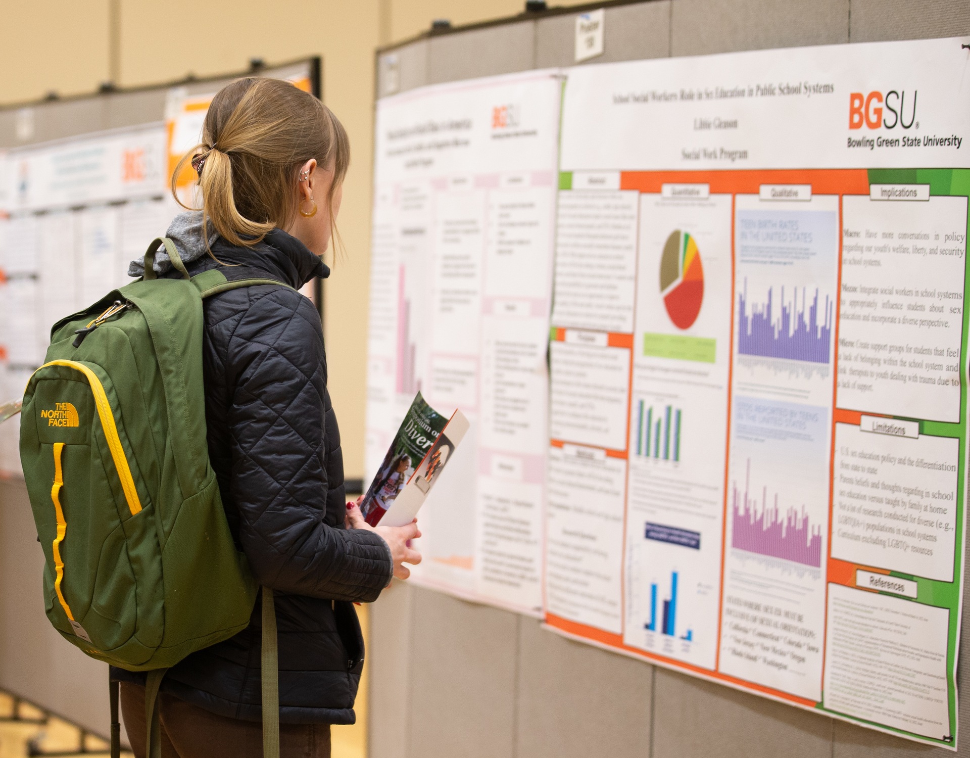 A BGSU student views a poster display at the Symposium on Diversity in the Bowen-Thompson Student Union Lenhart Grand Ballroom.