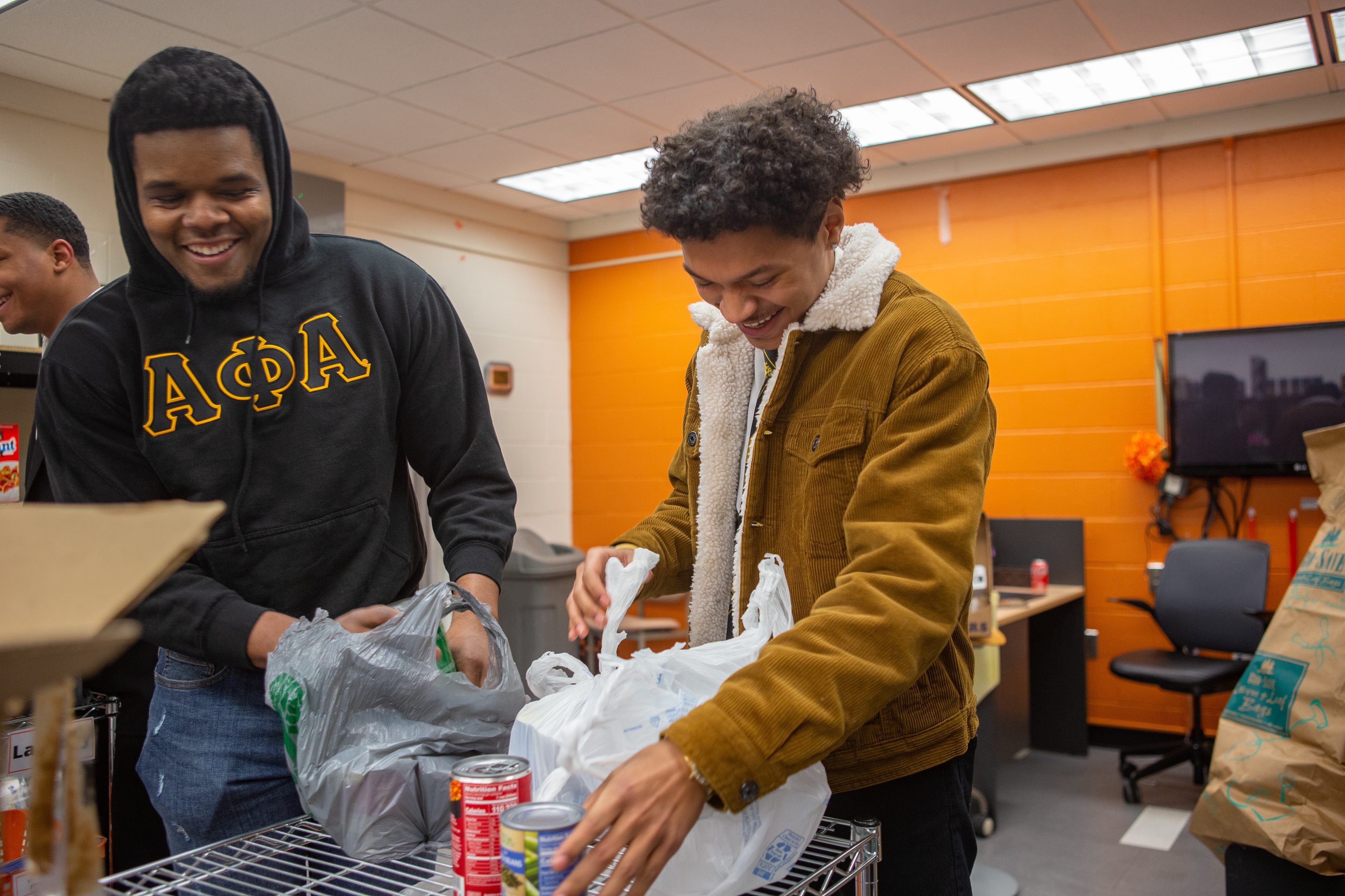 Students smile while volunteering at Falcon Food Pantry