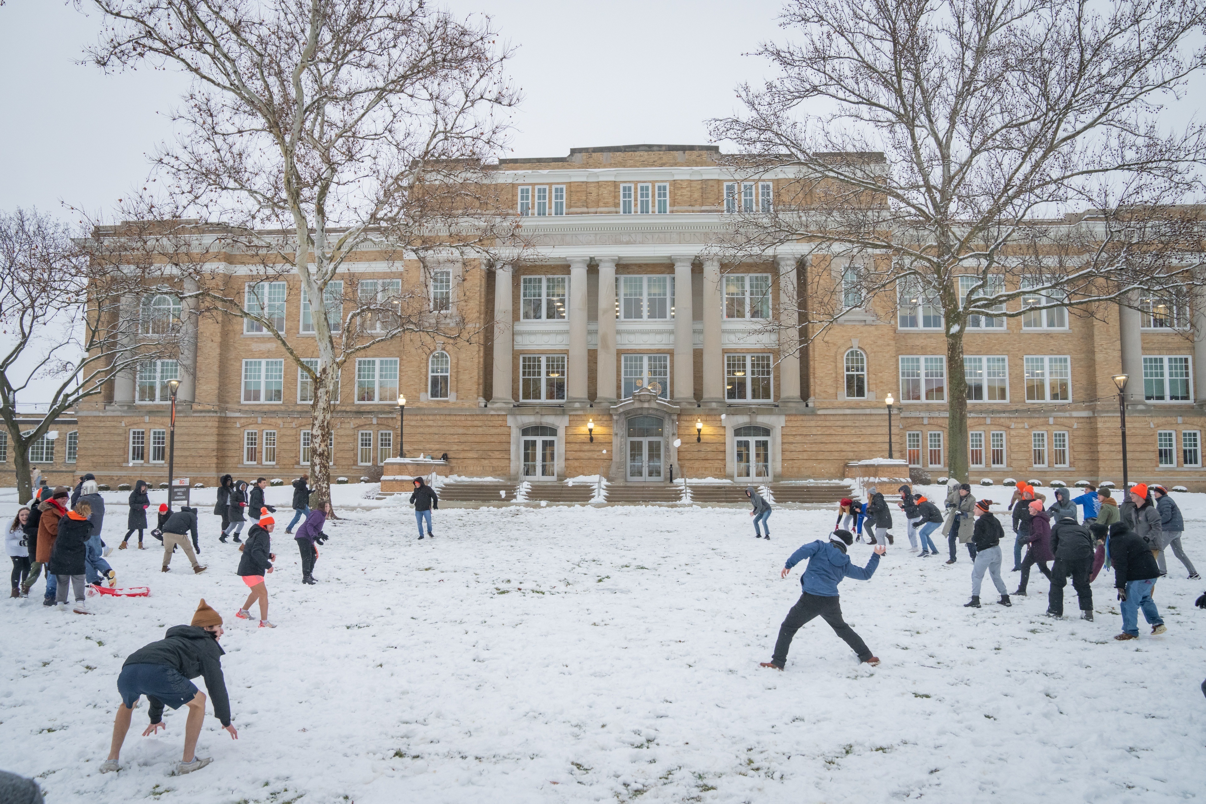 Large group of students have a snowball fight on BGSU campus 