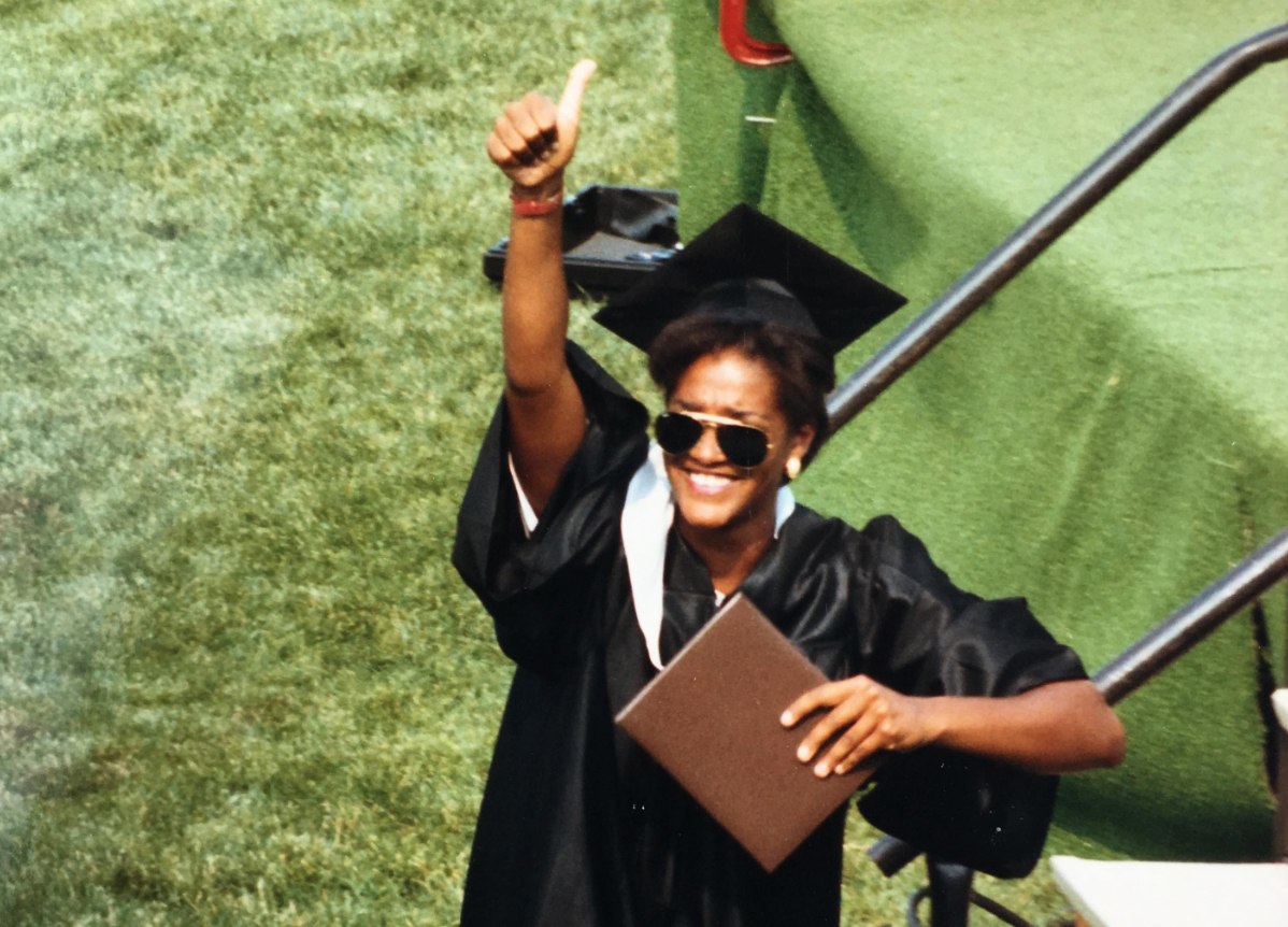 BGSU alumna Kelly McCoy Williams gives a thumbs up on graduation day in 1988