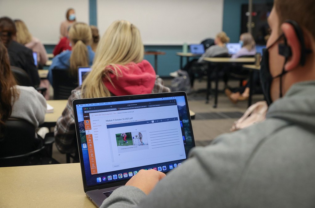 Nursing students completing coursework on computer in class