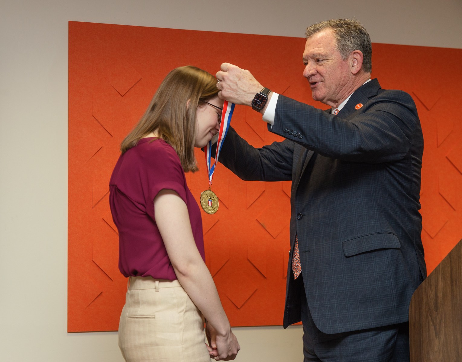 BGSU President Rodney K. Rogers presenting a medal to Christina Igl.