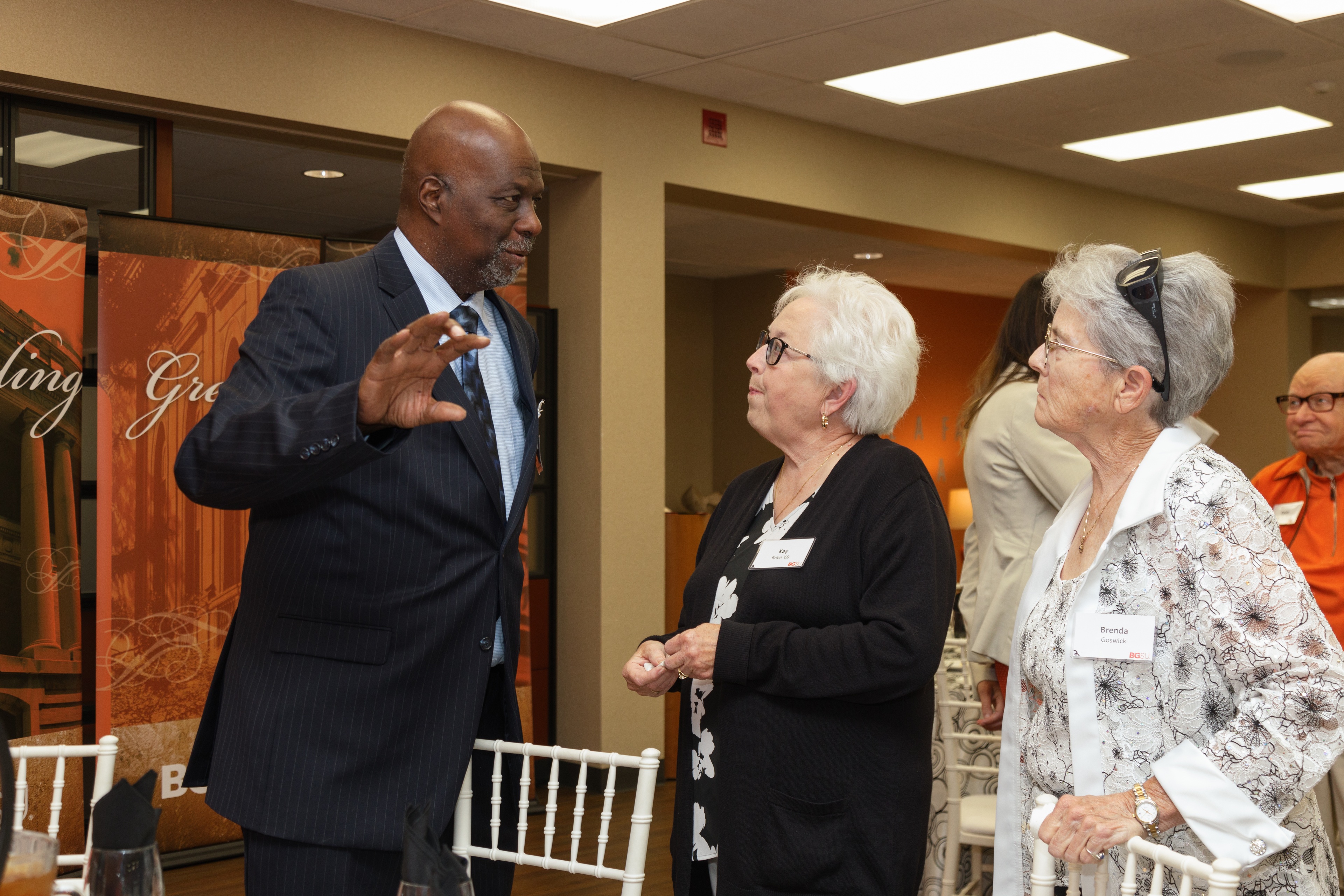 Dr. Joe B. Whitehead Jr. speaks with two women during a Golden Falcon reception
