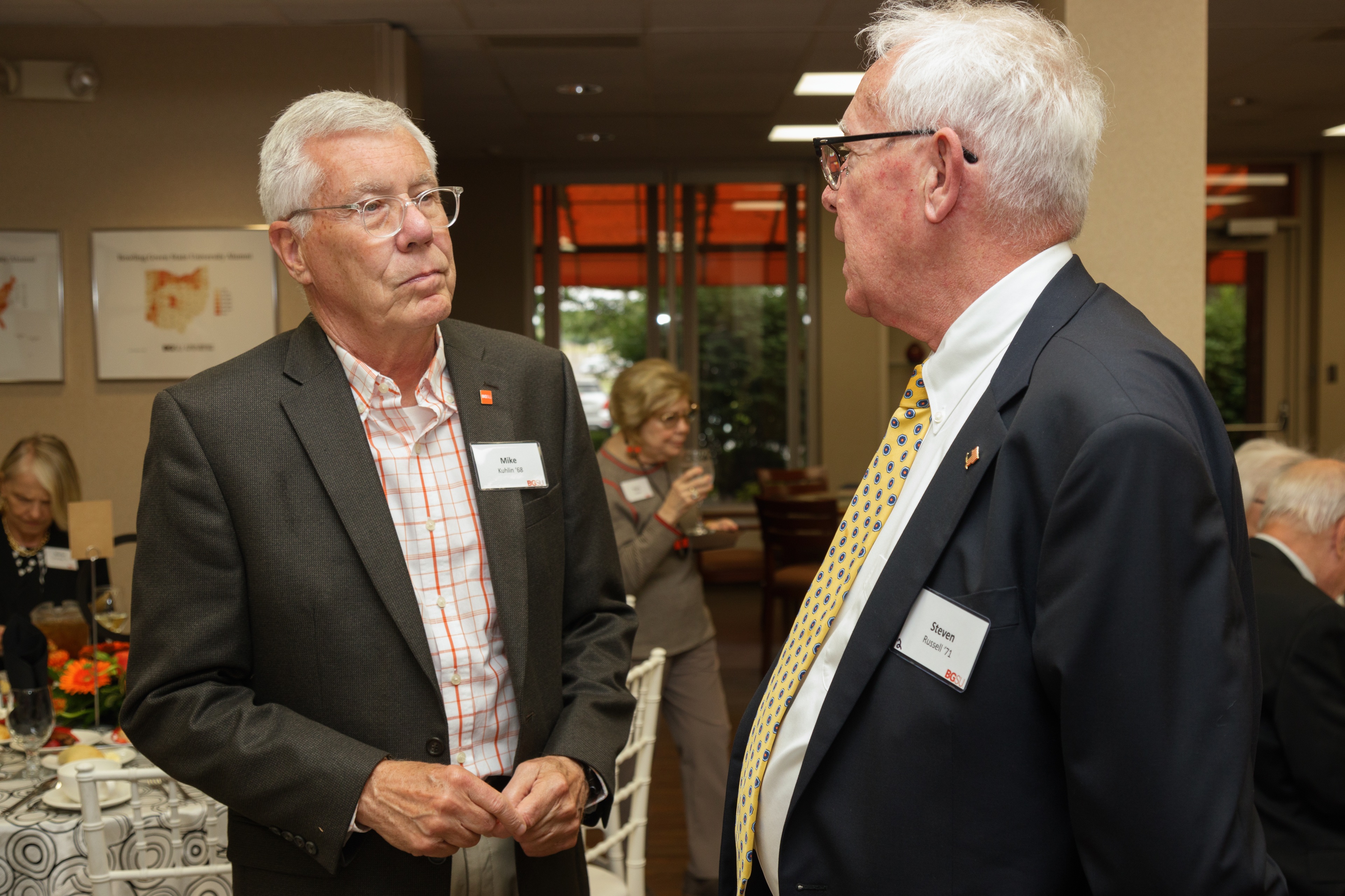 BGSU alumni Mike Kuhlin and Steven Russell talk at a reception