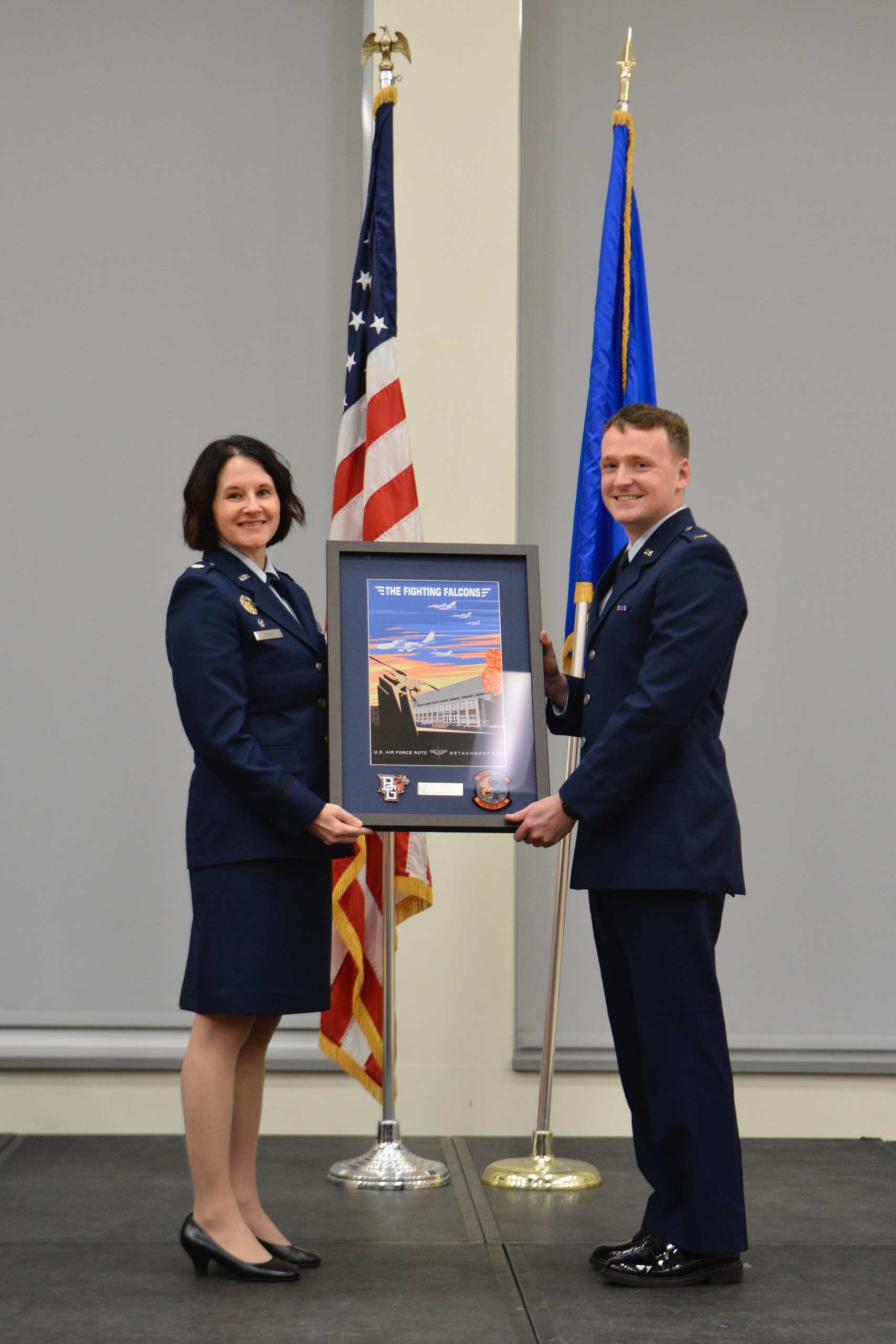  Lt. Col. Amy Grant and Nicholas Kowalski holding a framed award