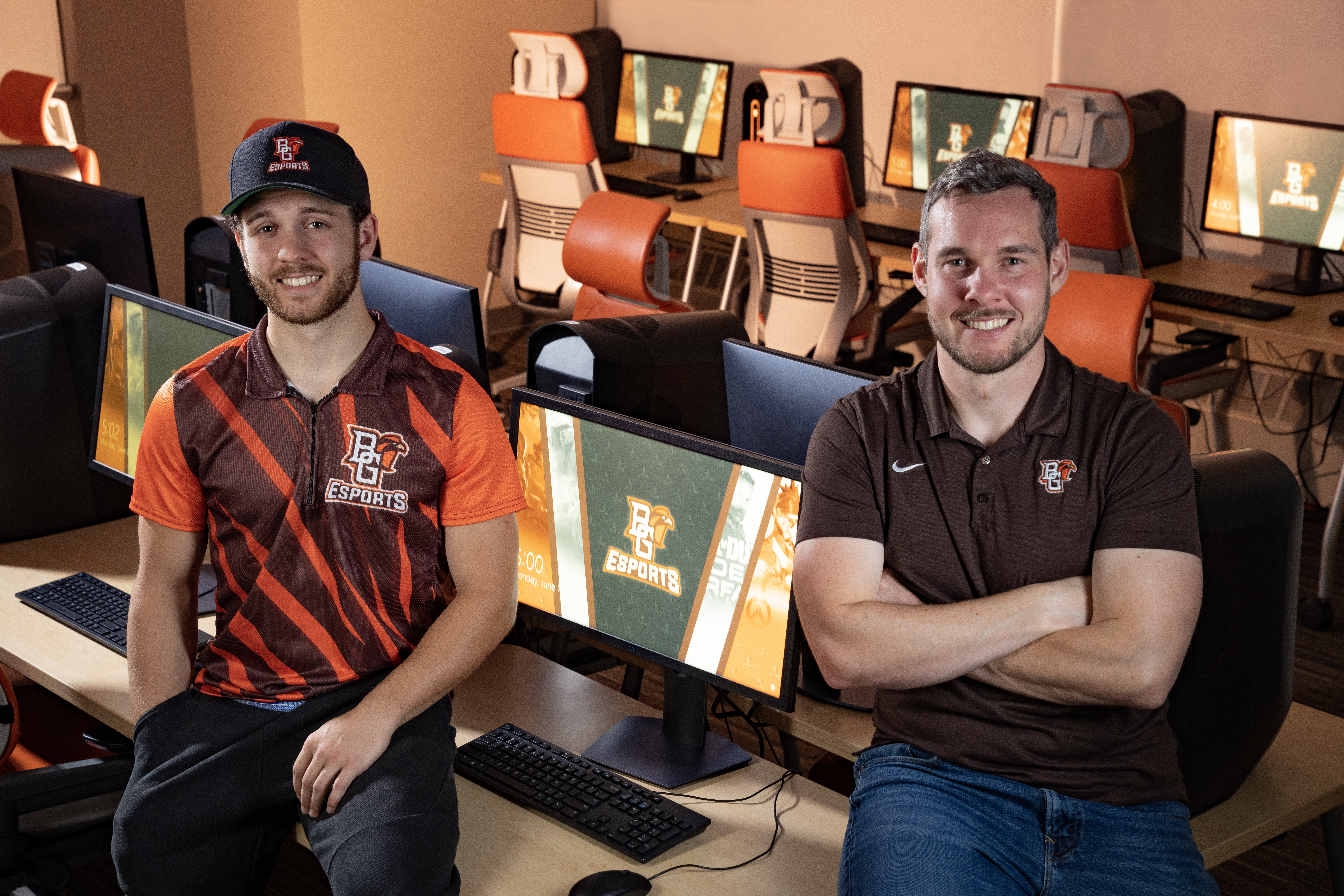 A student and program director in gaming room on BGSU campus.