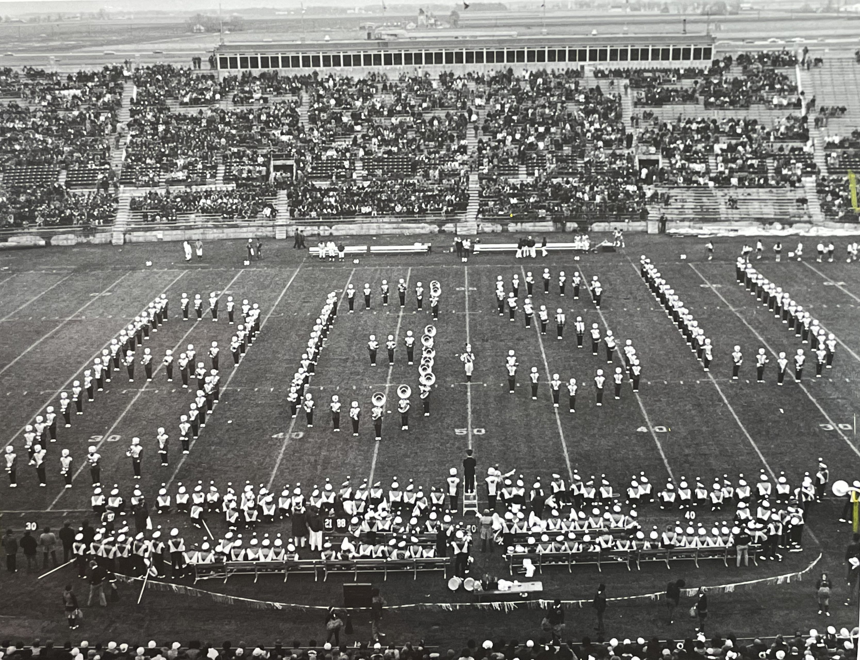 BGSU marching band members form the letters BGSU on a football field 