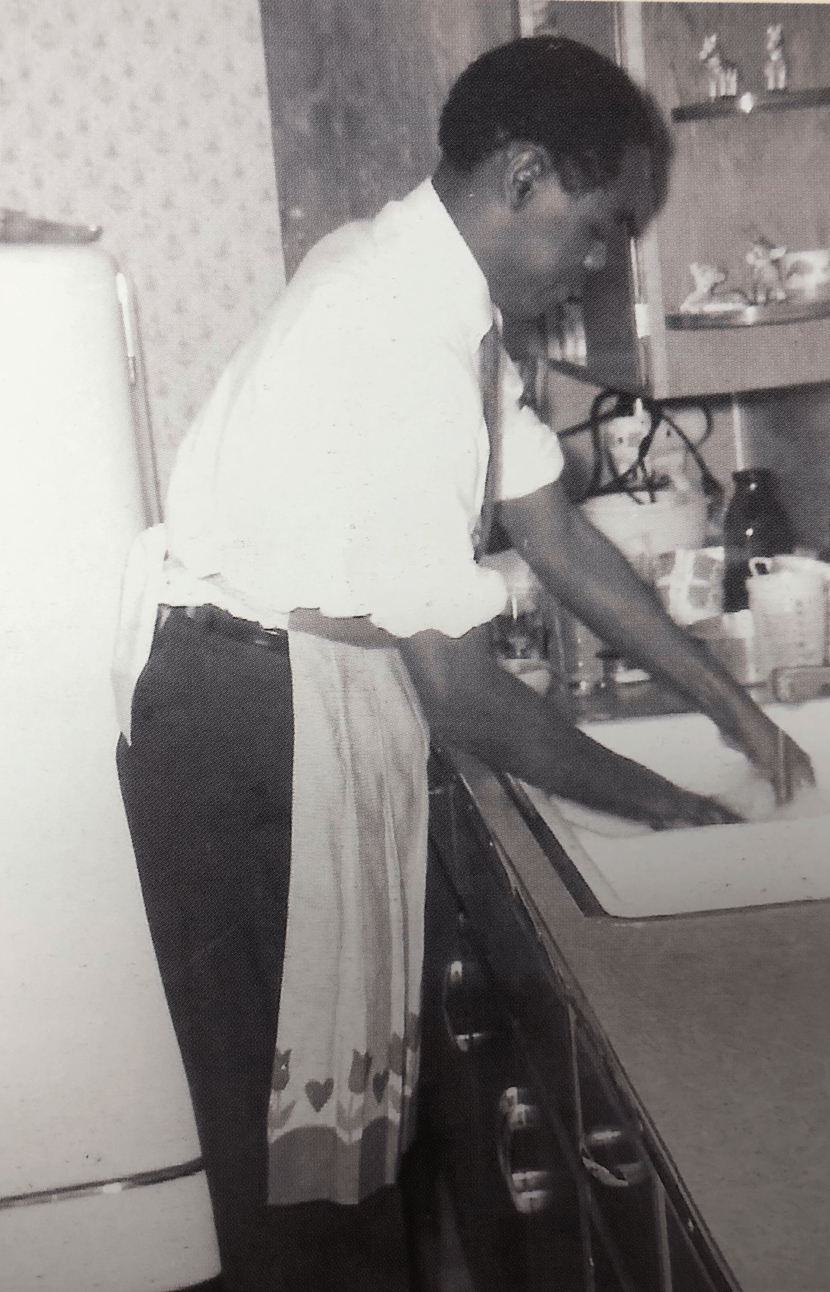 BGSU alumnus James B. Karugu washes dishes in a 1960s kitchen