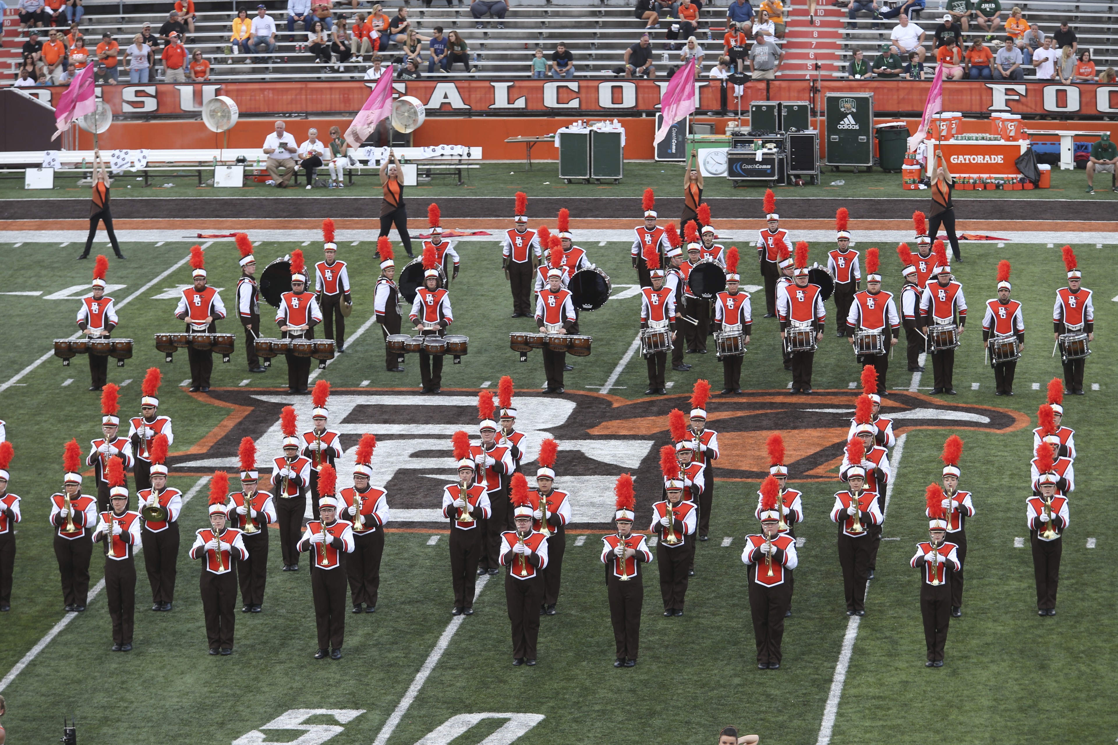 Marching band members stand near the 50 yard line at Doyt L. Perry Stadium