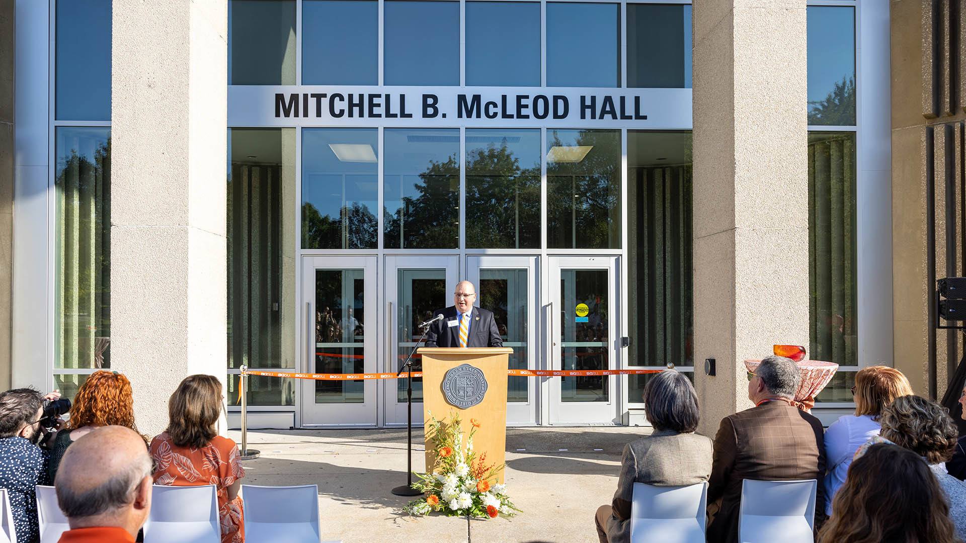 BGSU alumnus Mitchell B. McLeod speaks at the podium outside the renamed Mitchell B. McLeod Hall
