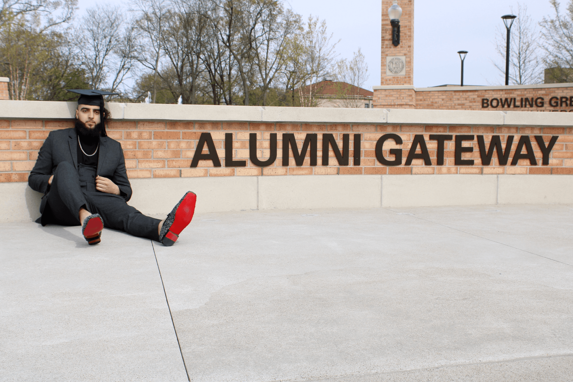 Alaa El Madhoun sits in front of Alumni Gateway on the BGSU campus.