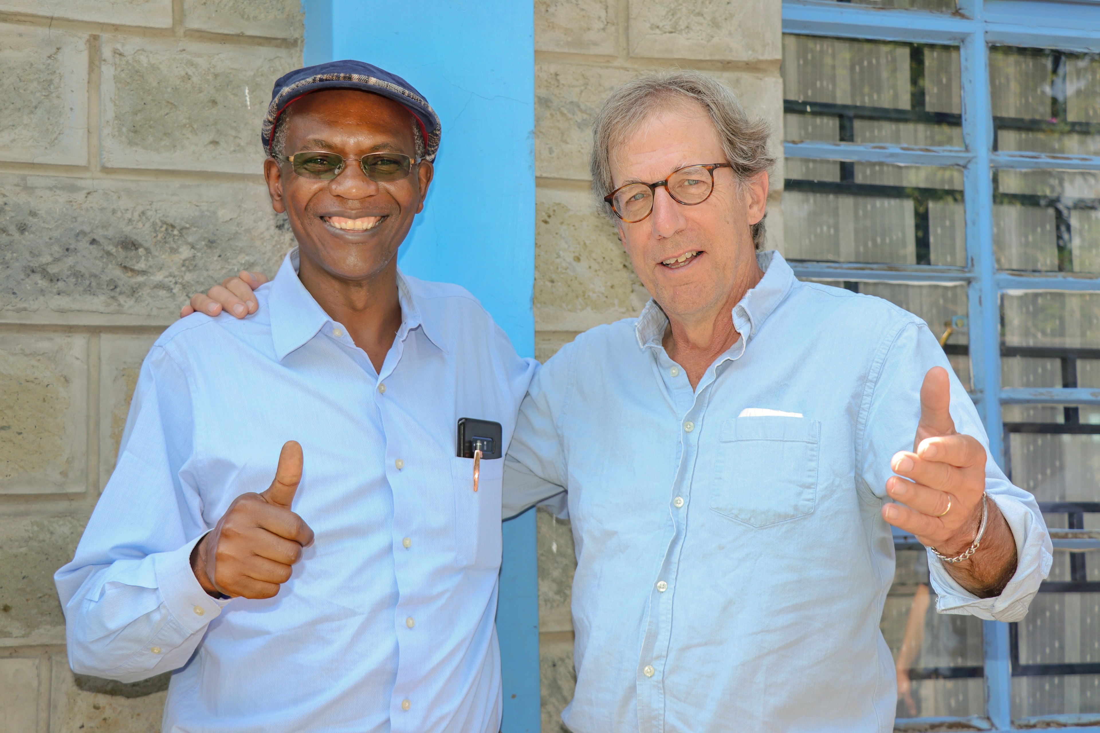 BGSU professors Dr. Kefa Otiso and Dr. George Bullerjahn smile and give thumbs up