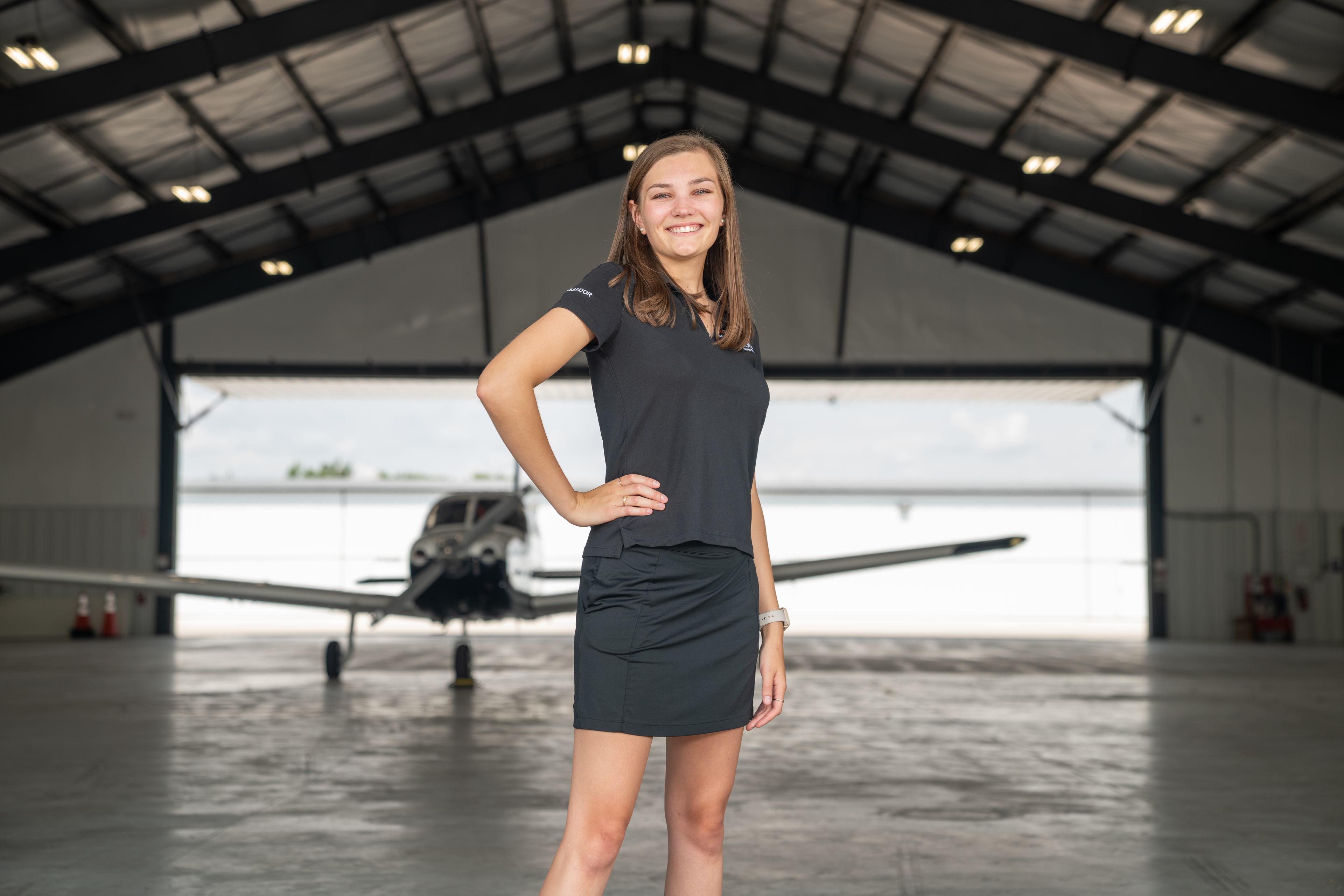 Olivia Thornton poses in an airplane hangar at the BG Flight Center.