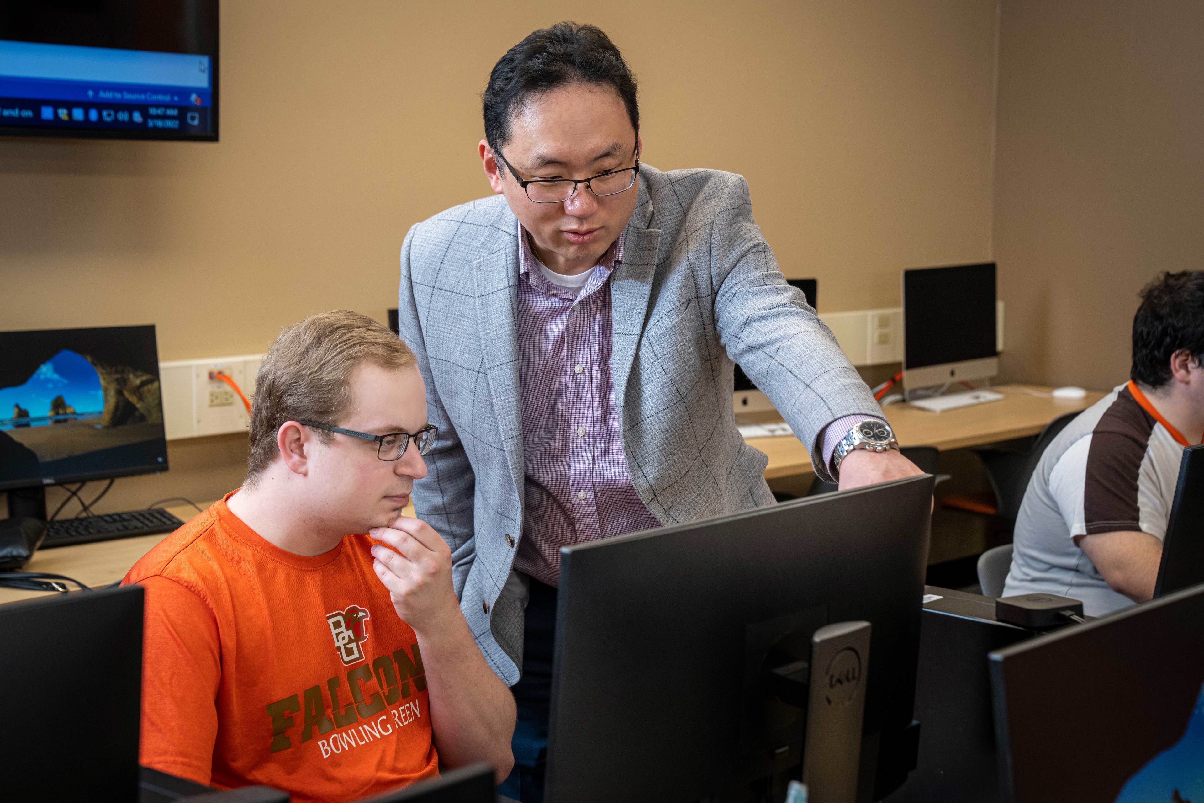 BGSU Computer Science Department chair Dr. JK Jake Lee points to a student's computer.