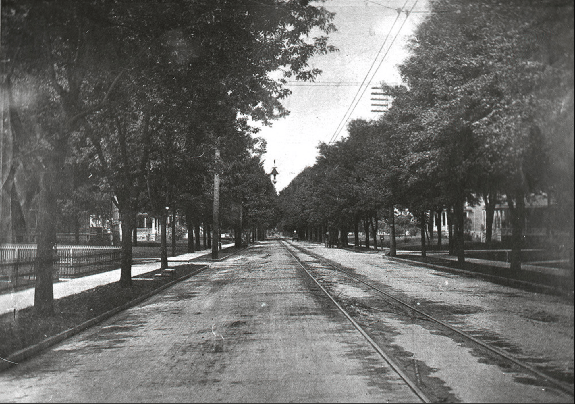 Historic photo shows an interurban rail line running through a residential area on Bowling Green's North Main Street in the early 1900s. 