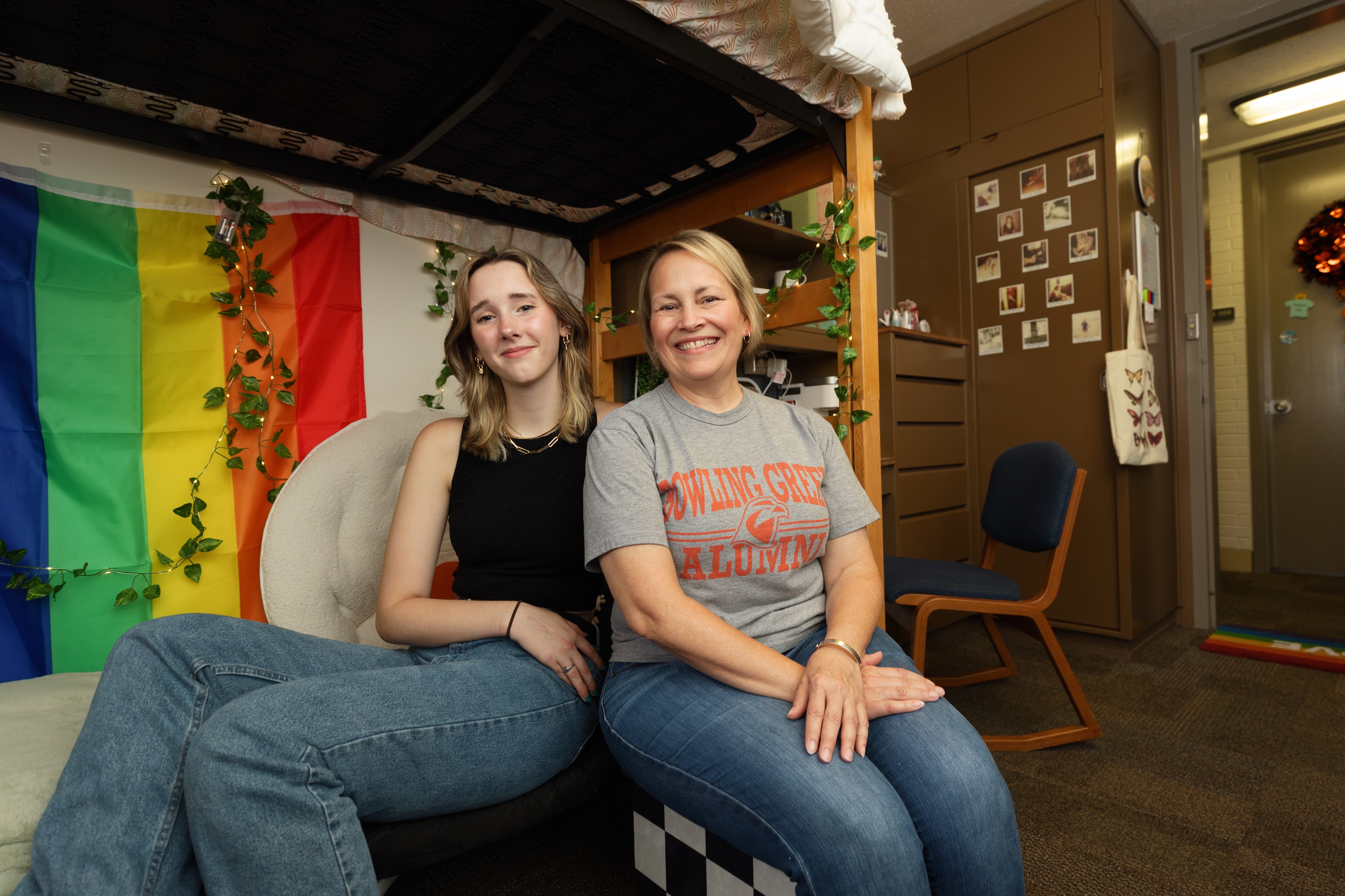 A daughter and stepmother smile in a BGSU residence hall room. 