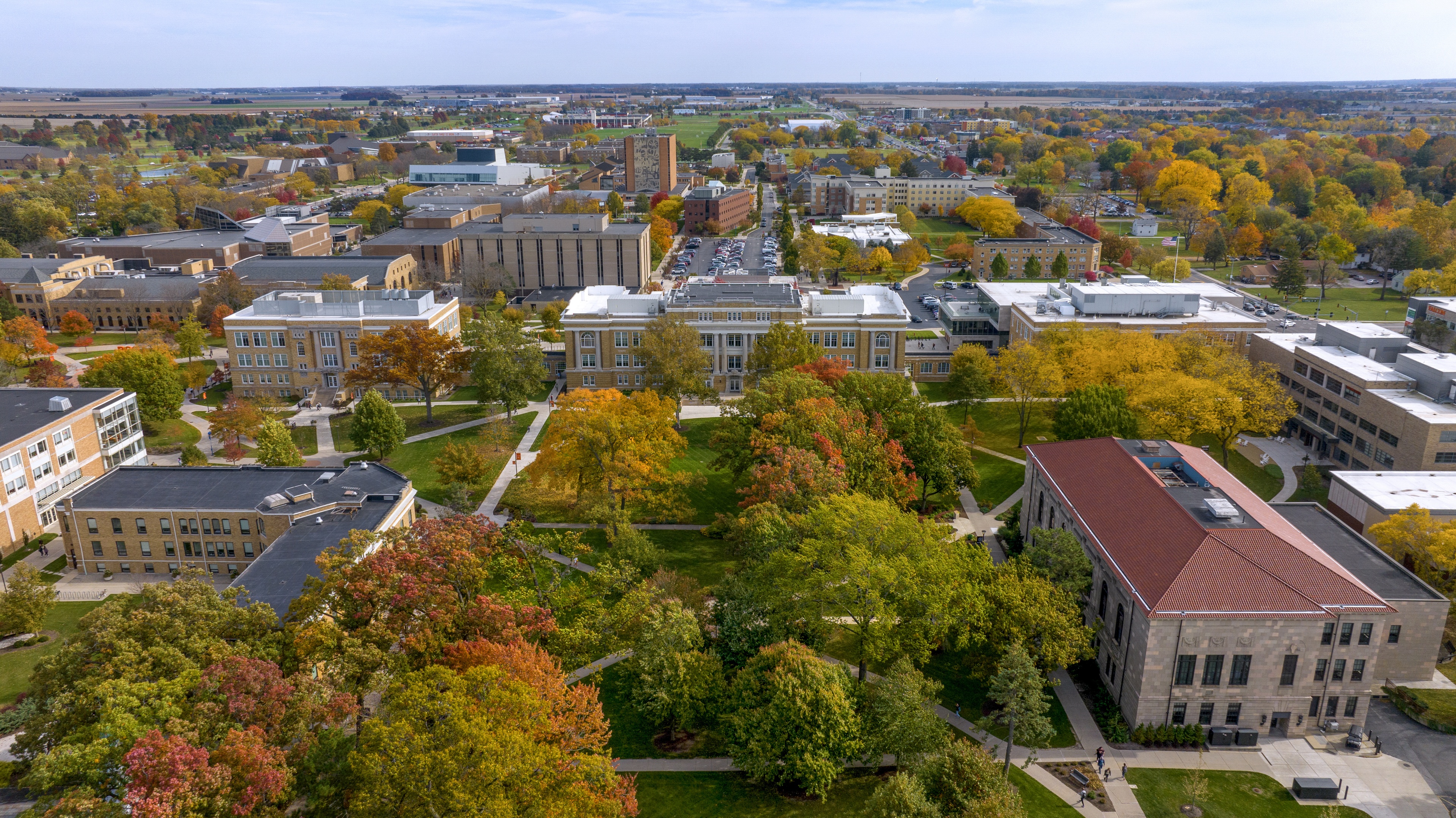 A photo taken by drone shows an aerial view of University Hall with trees in fall color