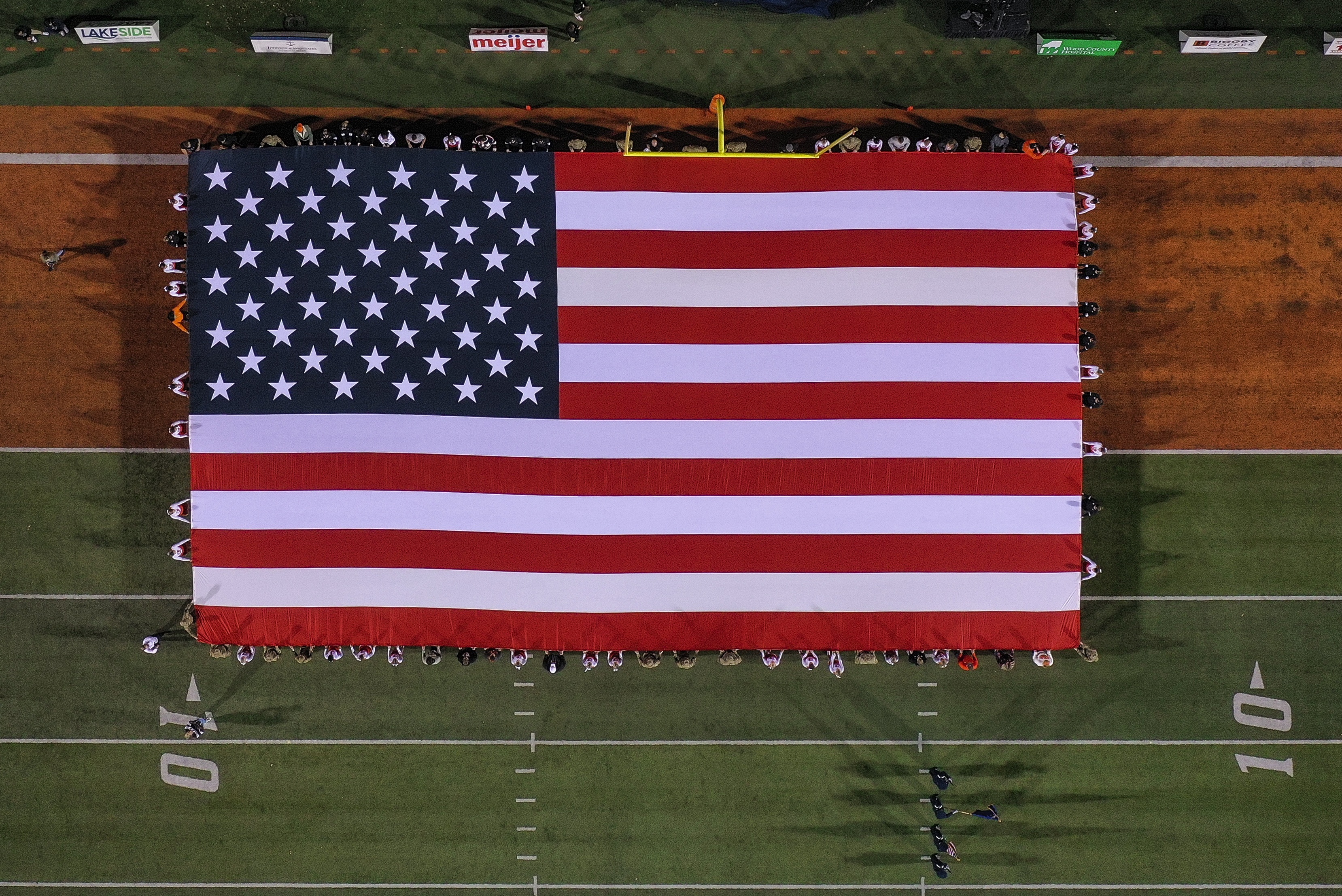 Large American flag is displayed in the end zone at Doyt L. Perry Stadium