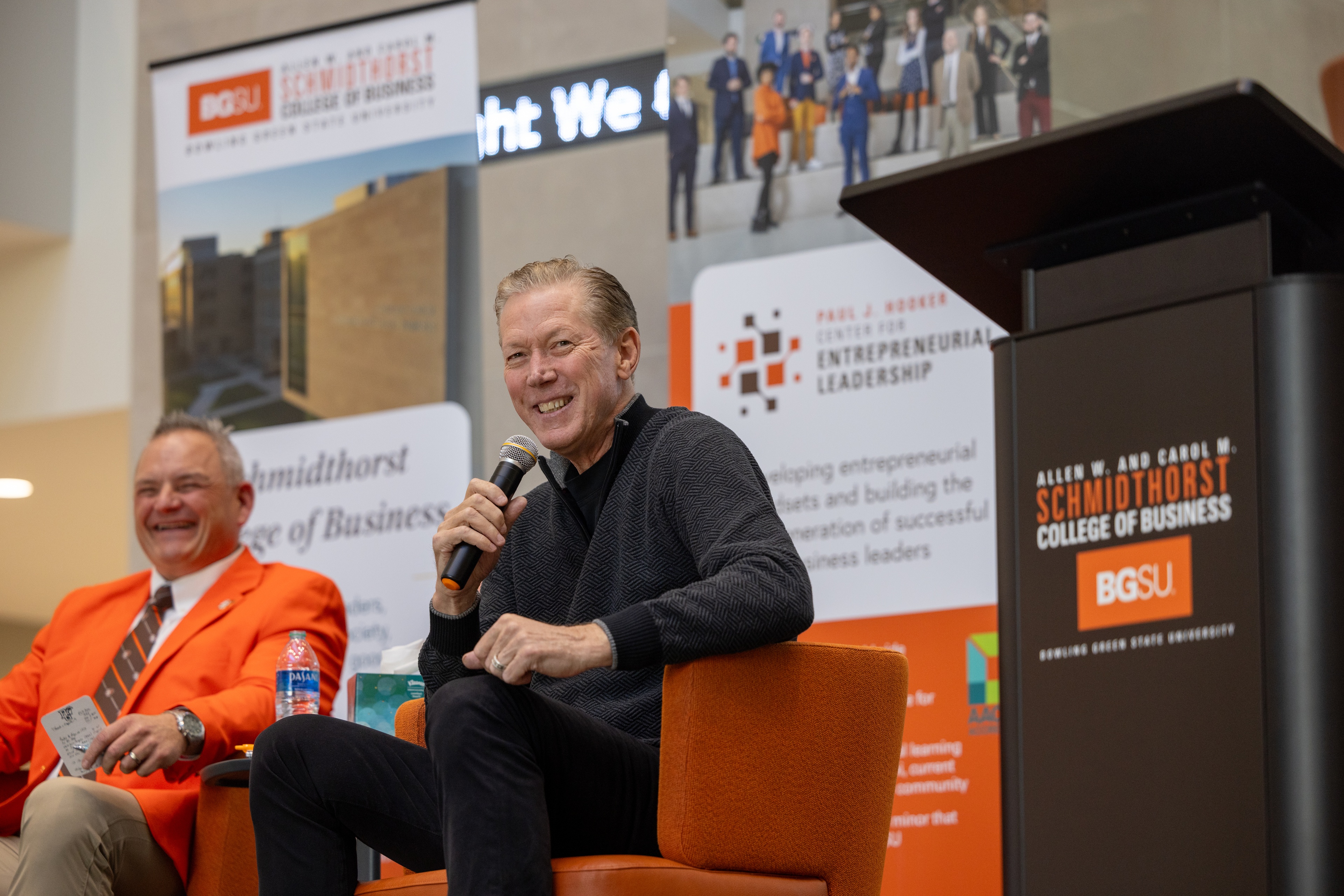 Two men are pictured sitting on a stage - at left is BGSU Athletics Director Derek van der Merwe and at right is MLB hall of fame pitcher Orel Hershiser