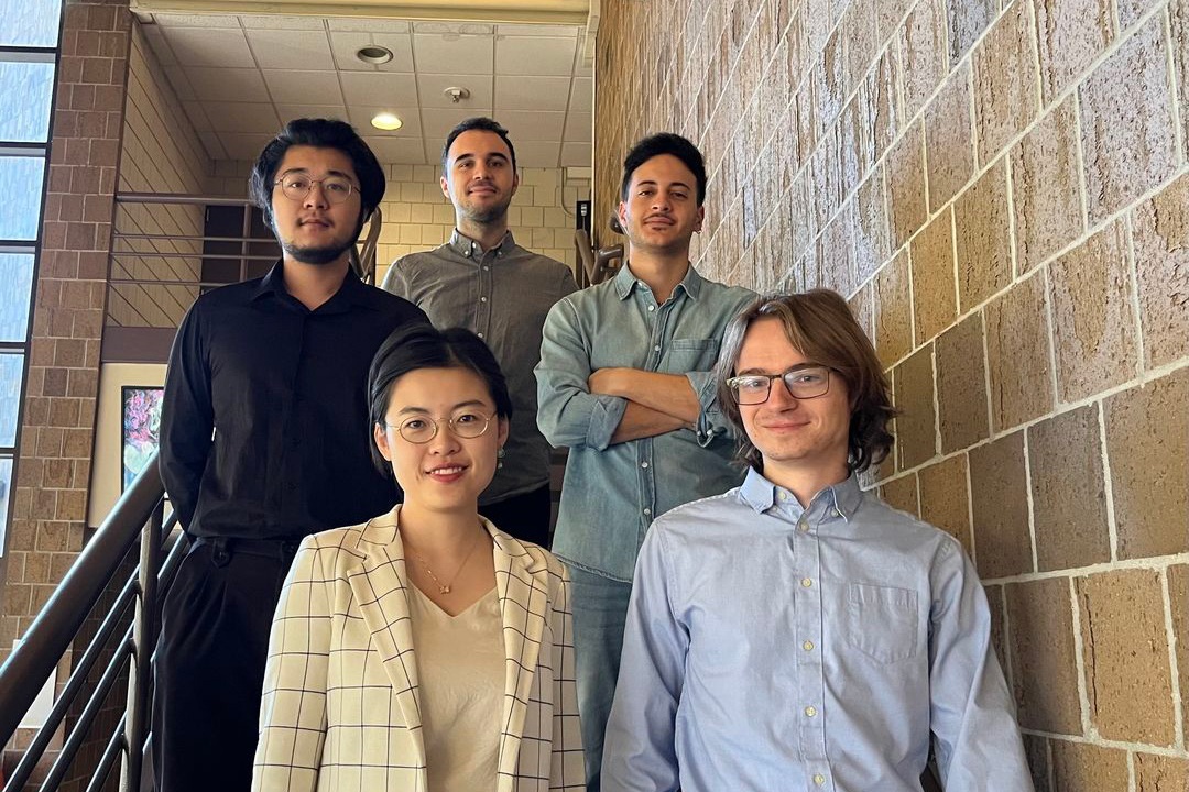 Five BGSU piano students stand on a staircase 