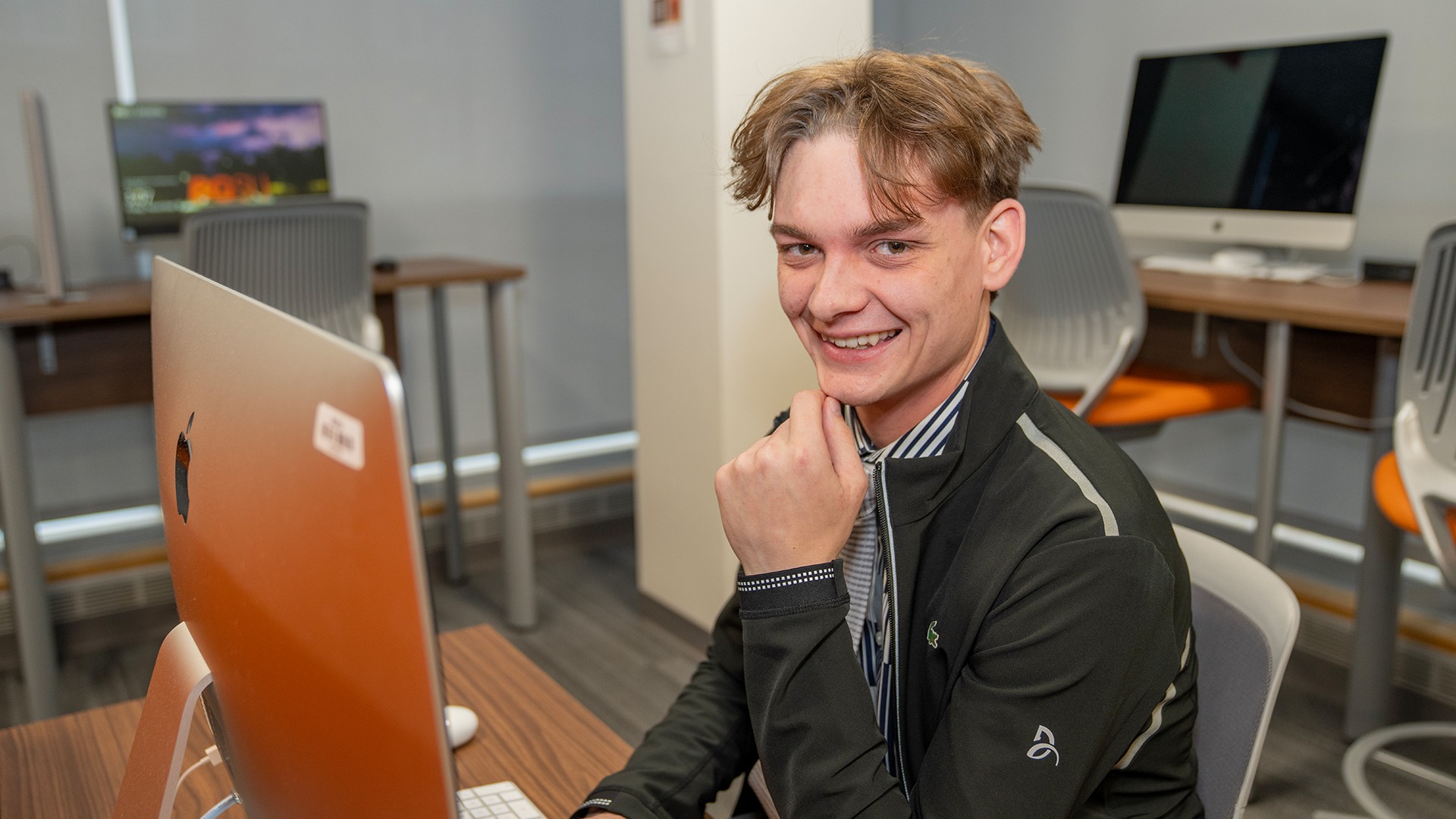 BGSU student sitting in front of a computer in a lab at the University.