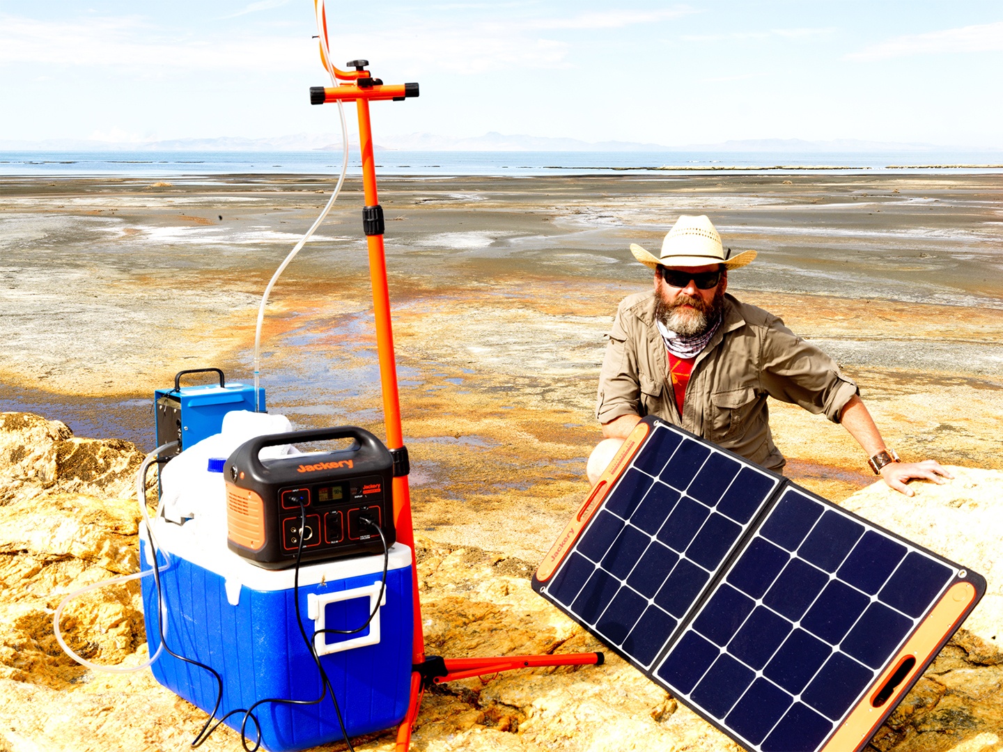 Dr. James Metcalf collects air and water samples in a desert background near the Great Salt Lake in Utah.
