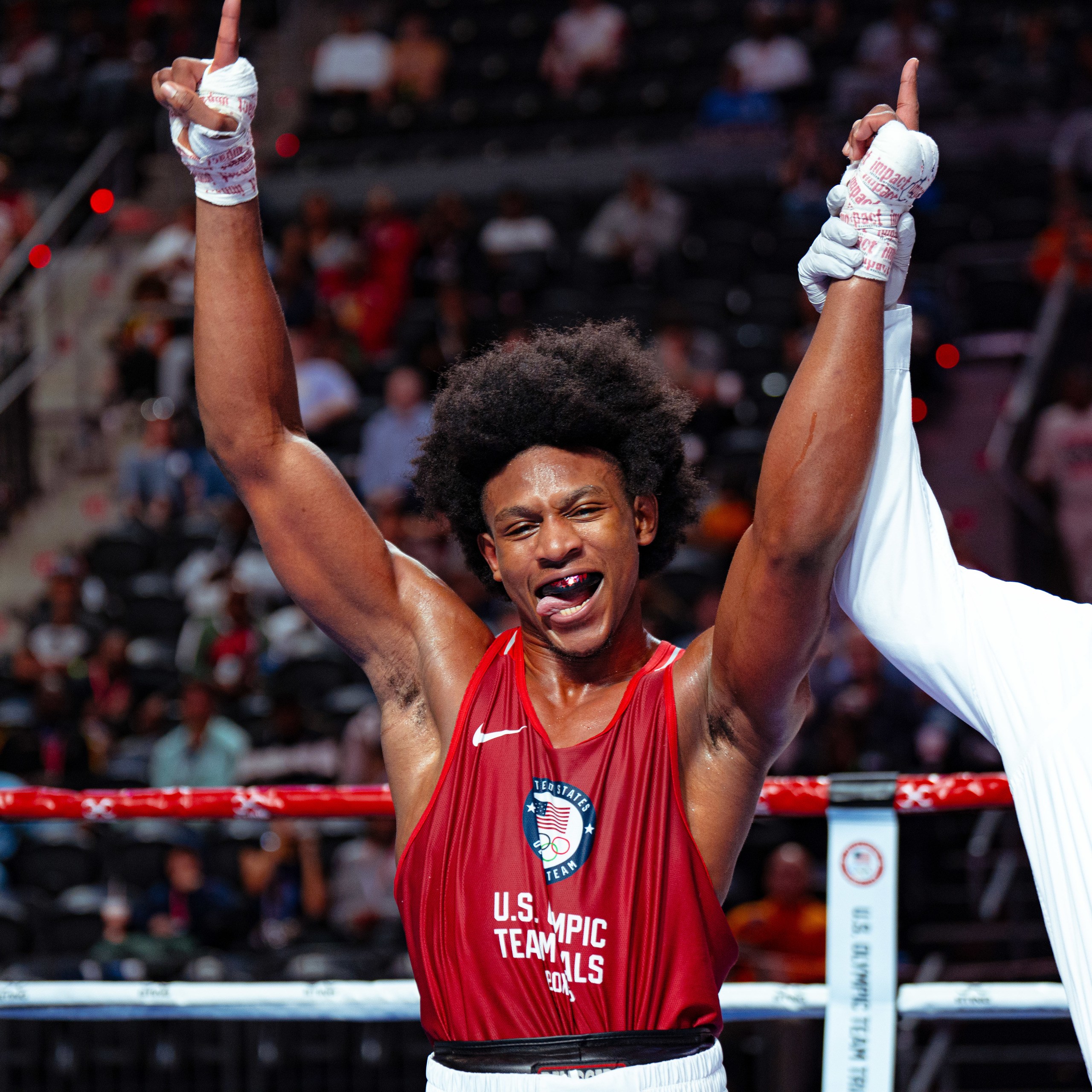 A boxer raises his arms in celebration