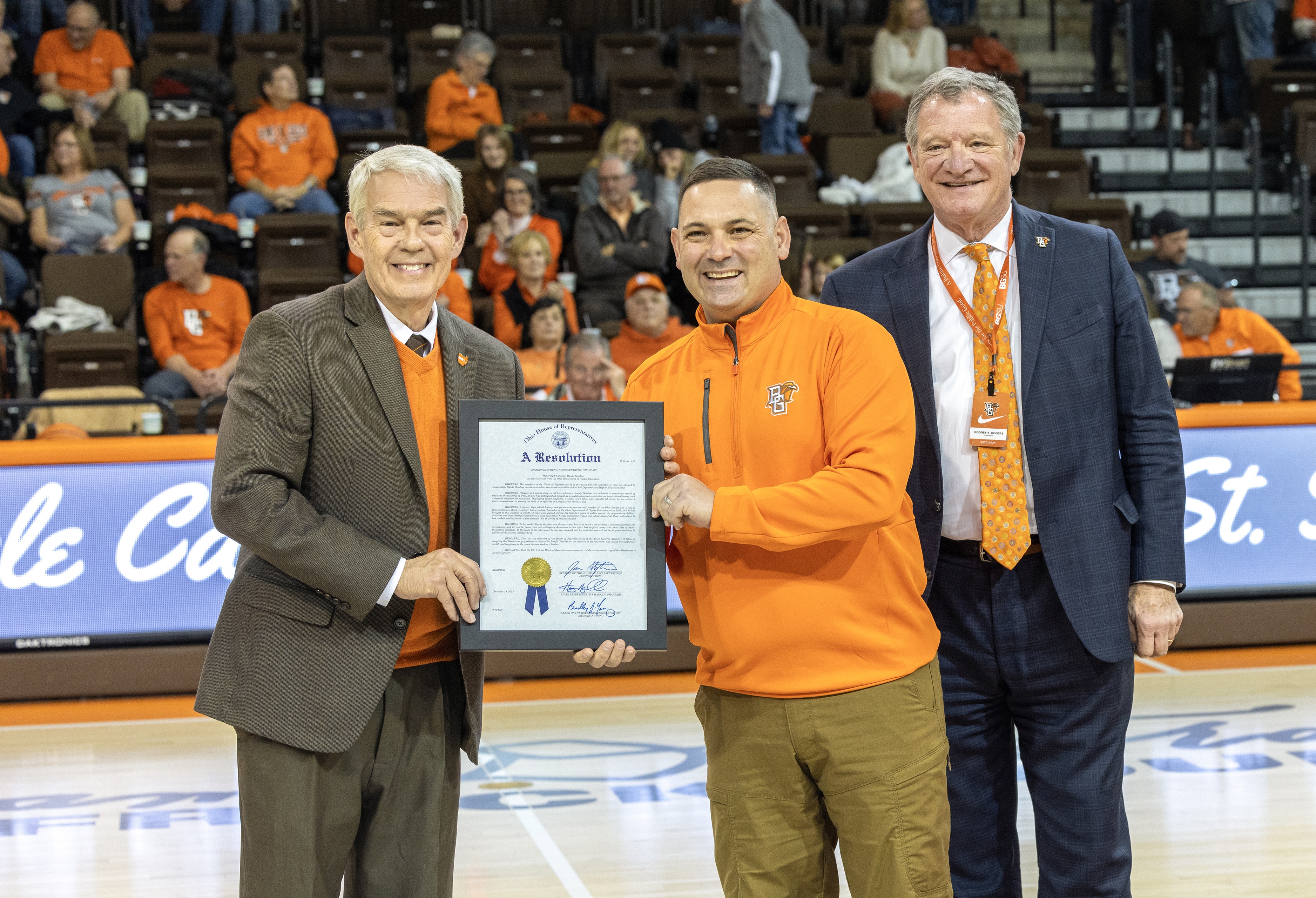 Ohio Department of Higher Education Chancellor Randy Gardner, Ohio Rep. Haraz Ghanbari and BGSU President Rodney K. Rogers stand on the court at the Stroh Center. 