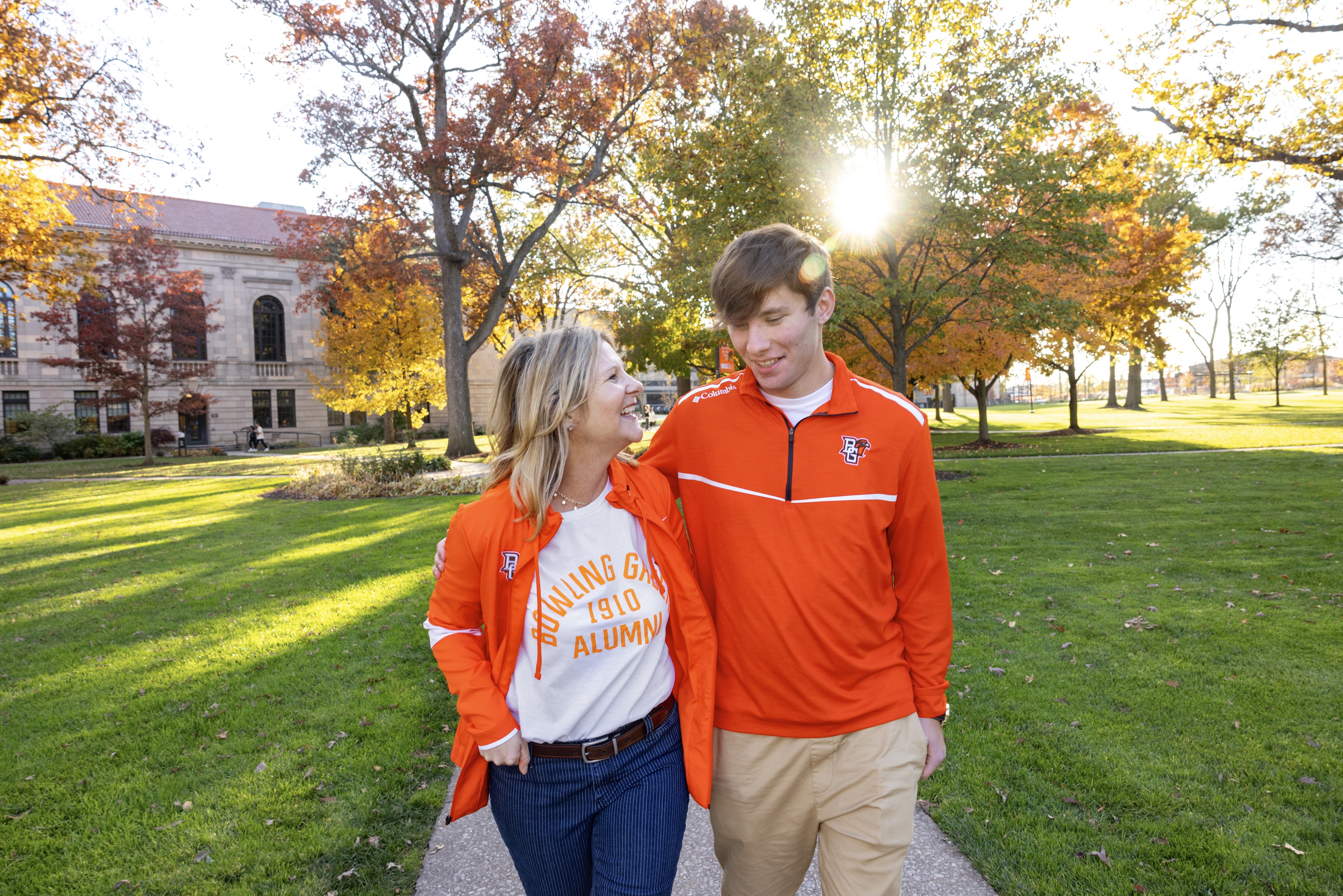 Tricia and Andrew Maasel walk through campus on a sunny fall day.