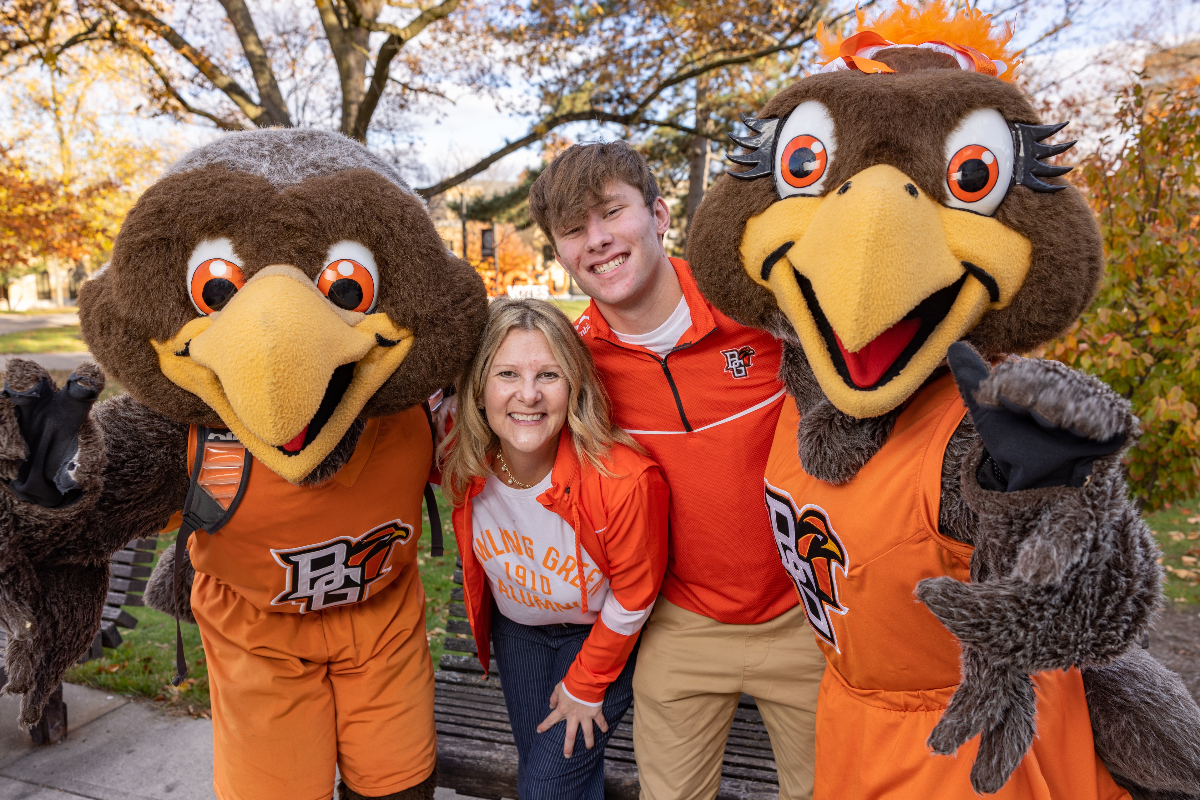 Tricia and Andrew Maassel pose for a photo with the BGSU Falcon mascots, Freddie and Freida Falcon. 