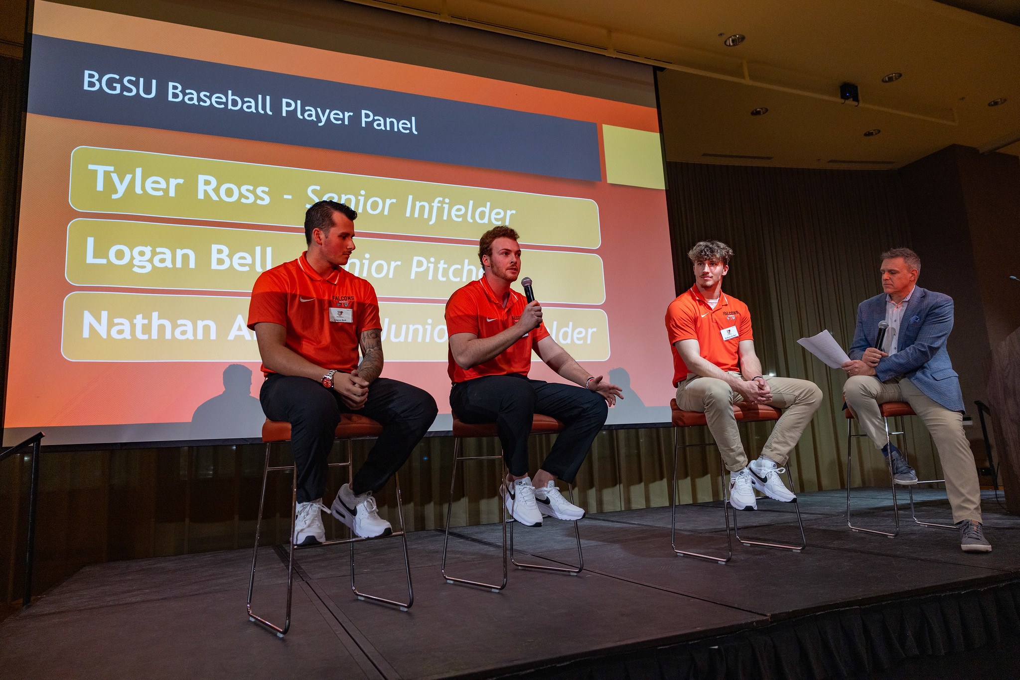 Three BGSU Falcon baseball players sit on stools and are asked questions by host Jay Crawford 