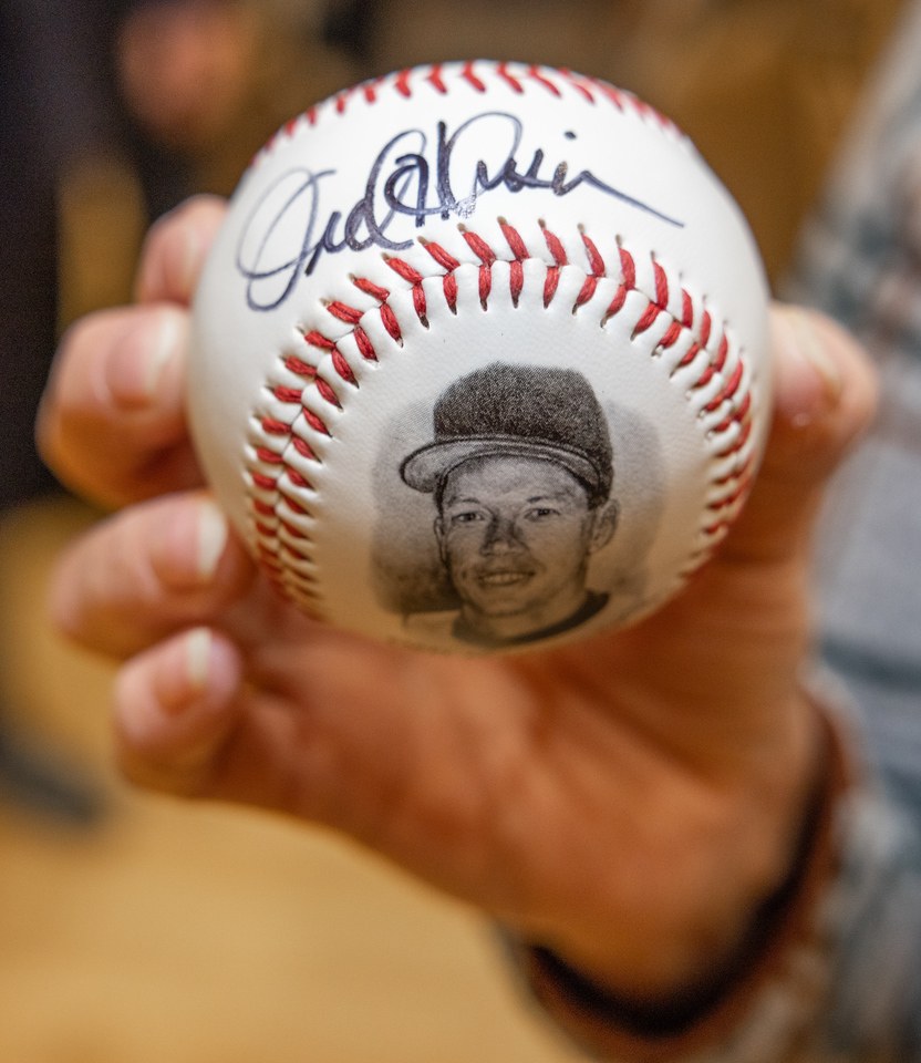 A baseball is printed with the image of Orel Hershiser and has his autograph 