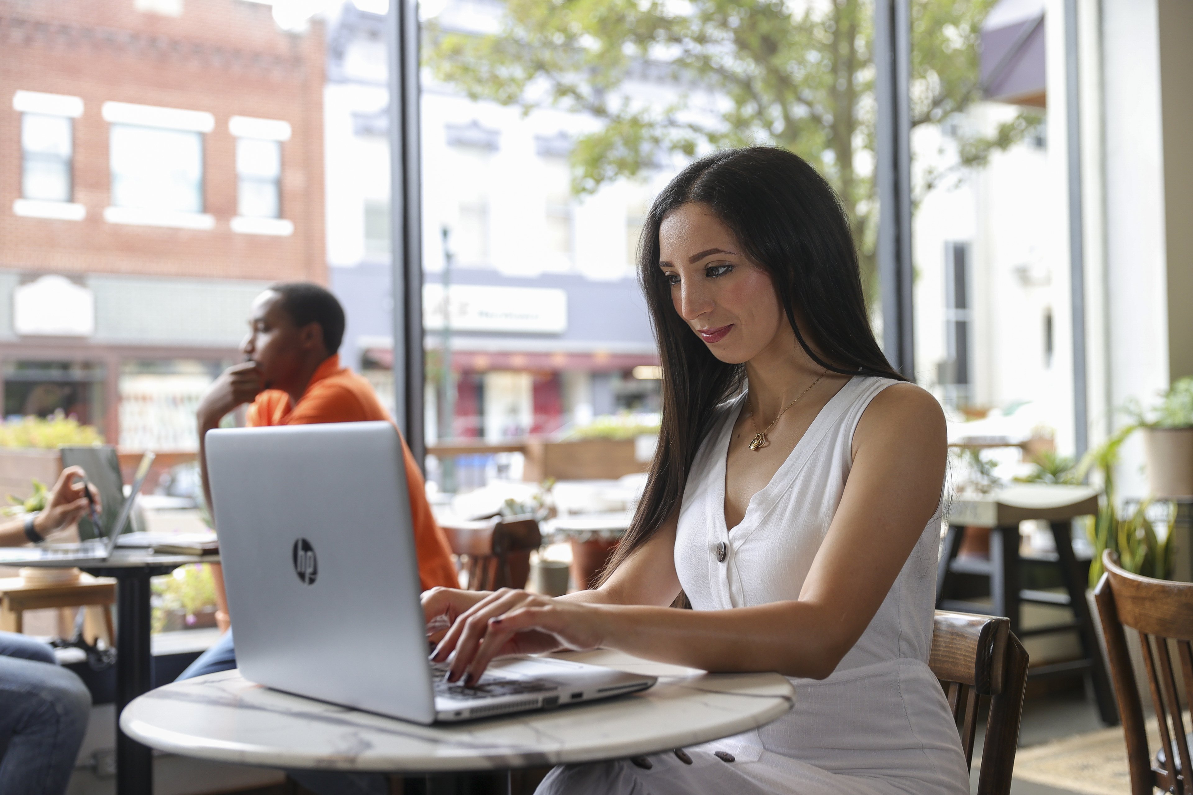 A female student works at her laptop inside of a coffee shop in downtown Bowling Green. 