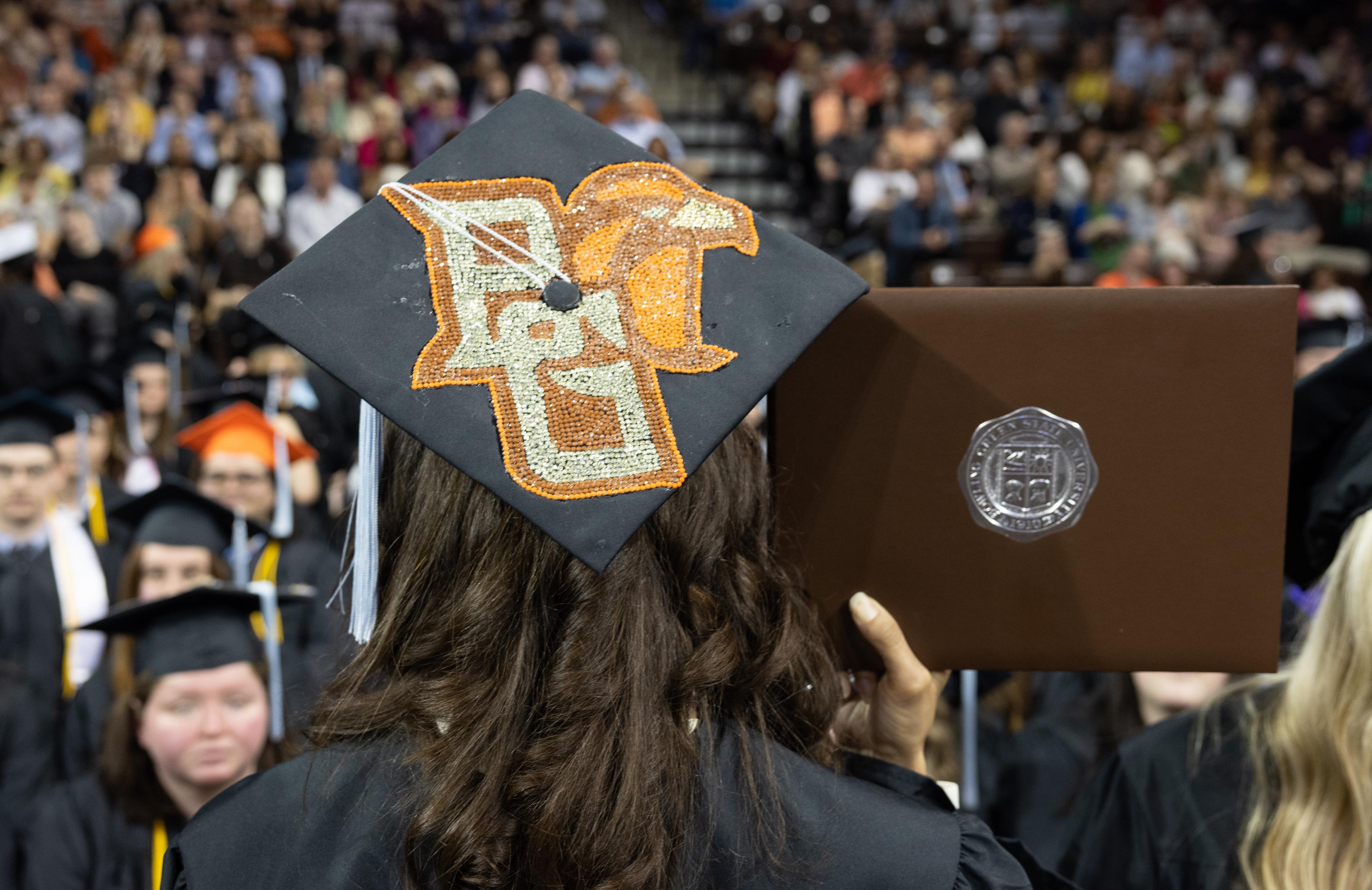 A Bedazzled BGSU logo appears on the top of a graduation cap