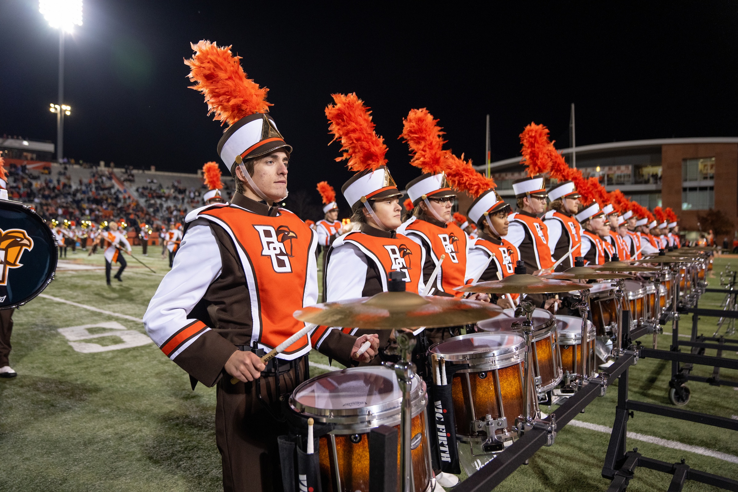 Falcon Marching Band members perform at a football game.
