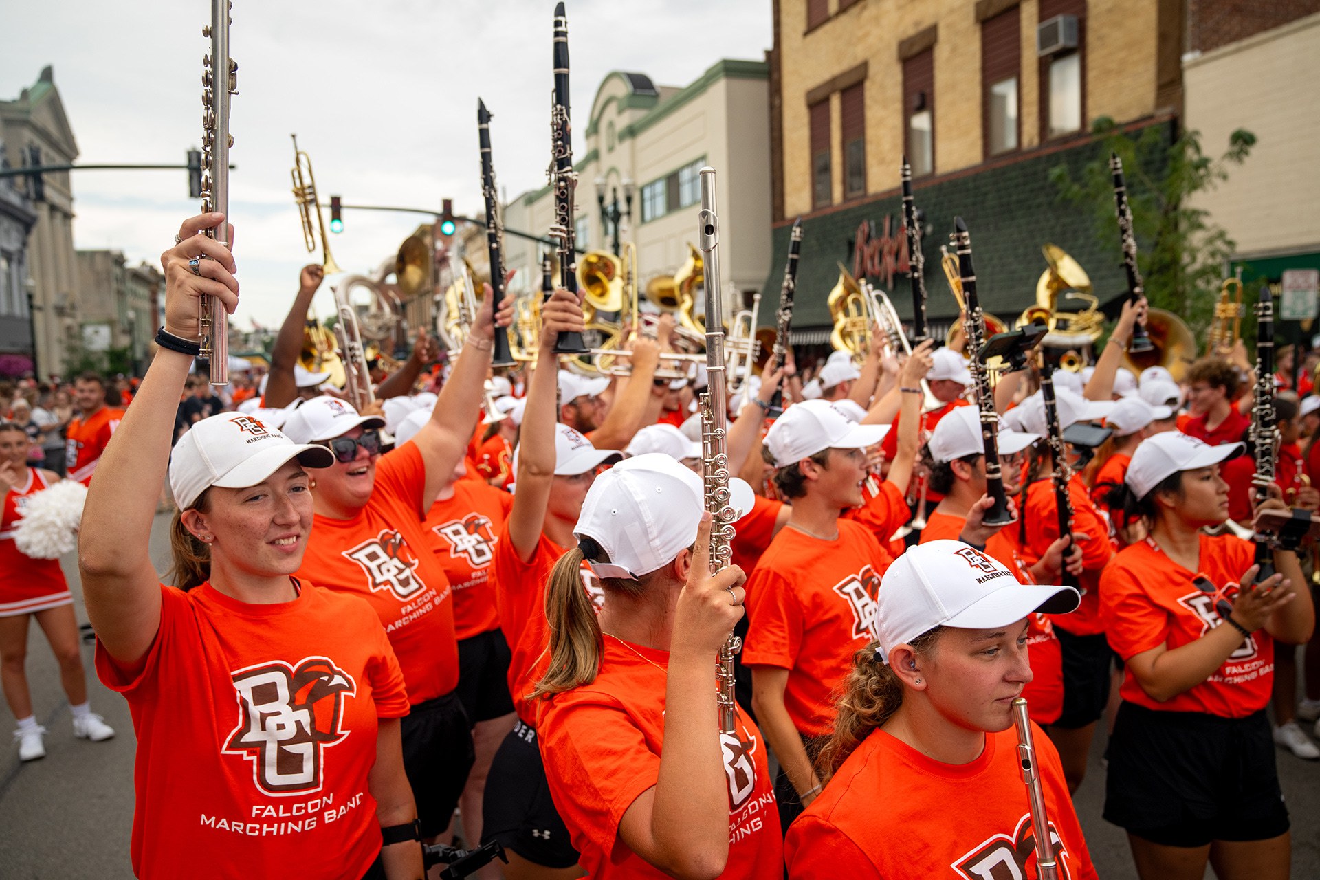 A group of BGSU Falcon Marching Band members performing.