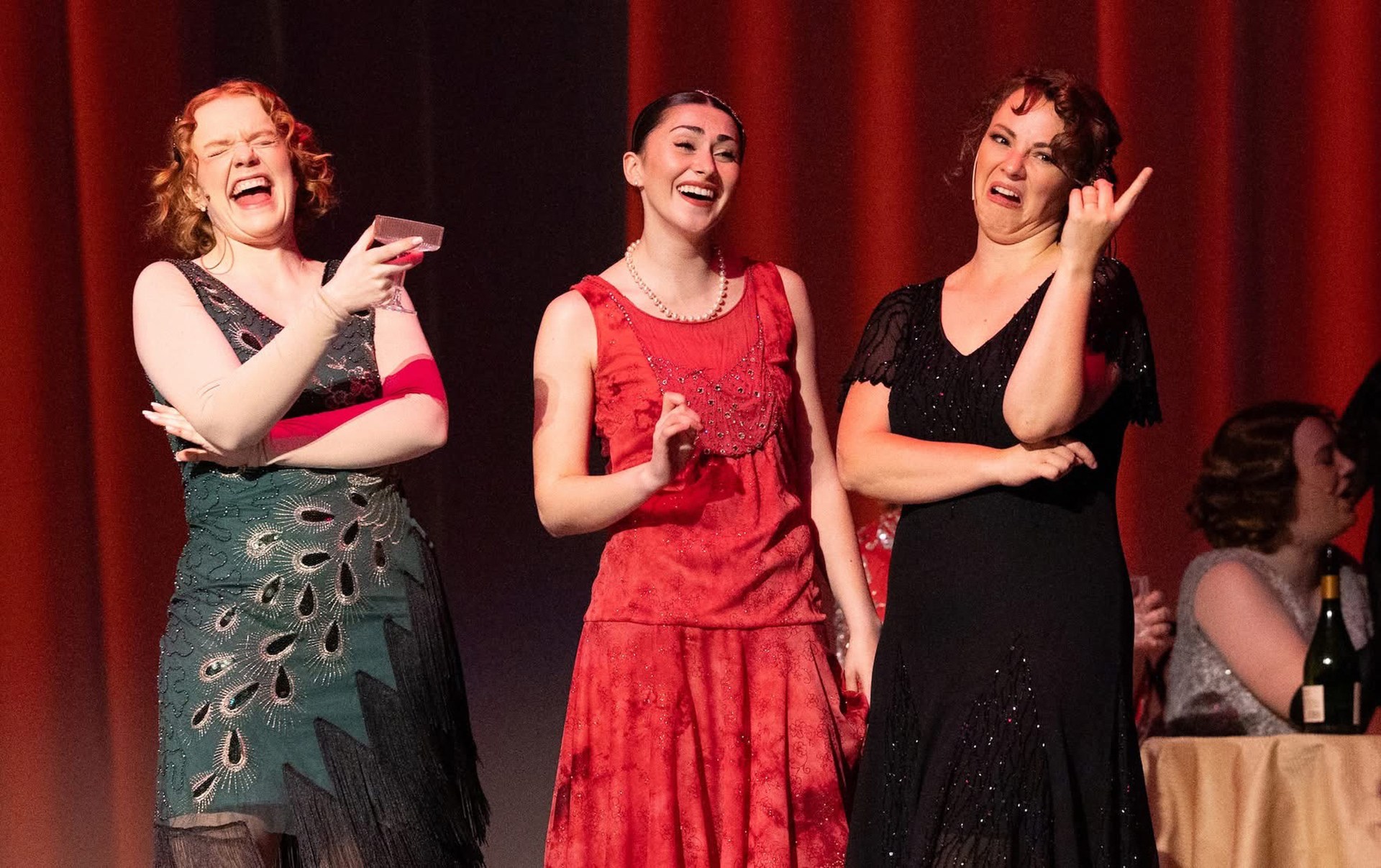 Three people perform on stage