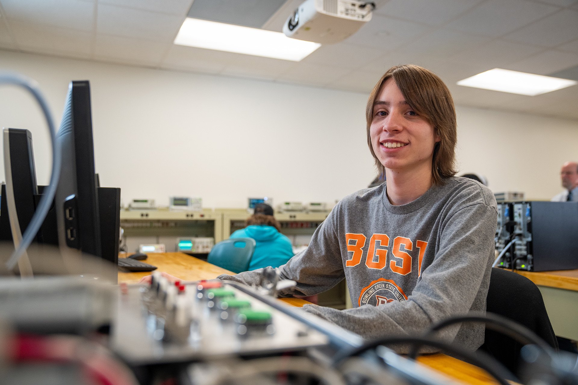  Students working in an electronics lab at BGSU Firelands with technical equipment.