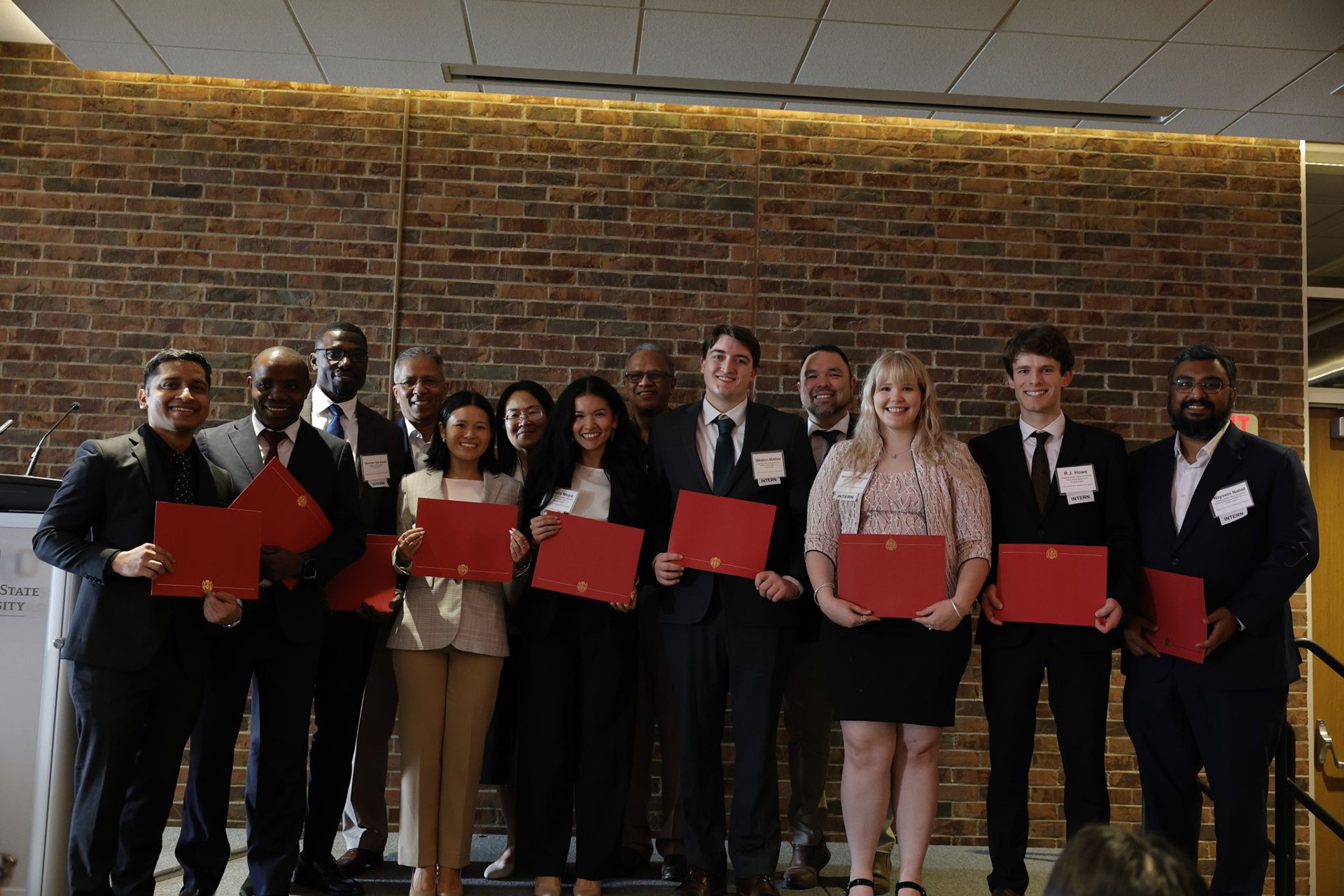 Students smile after receiving certificates.