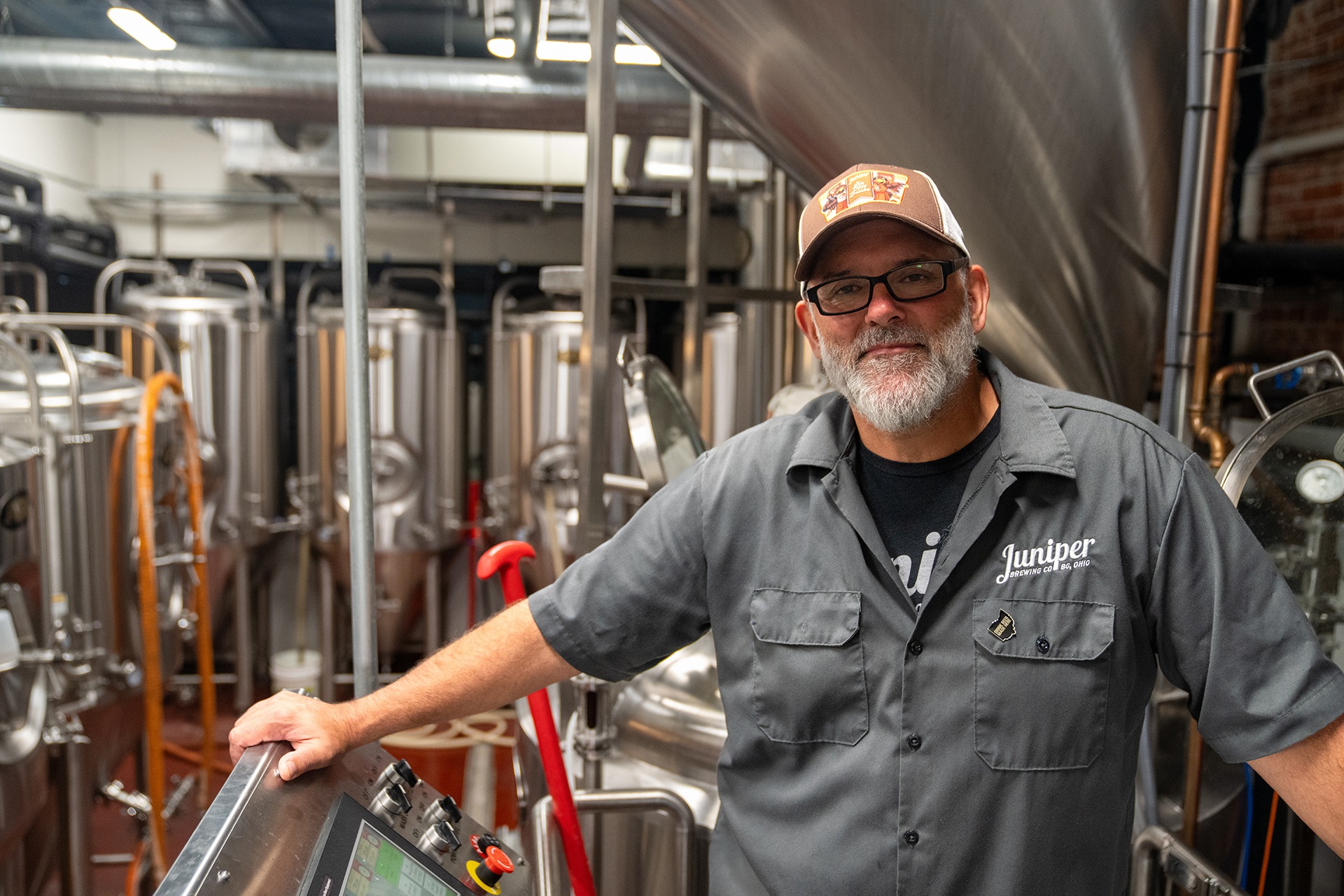 A man poses inside a brewery.