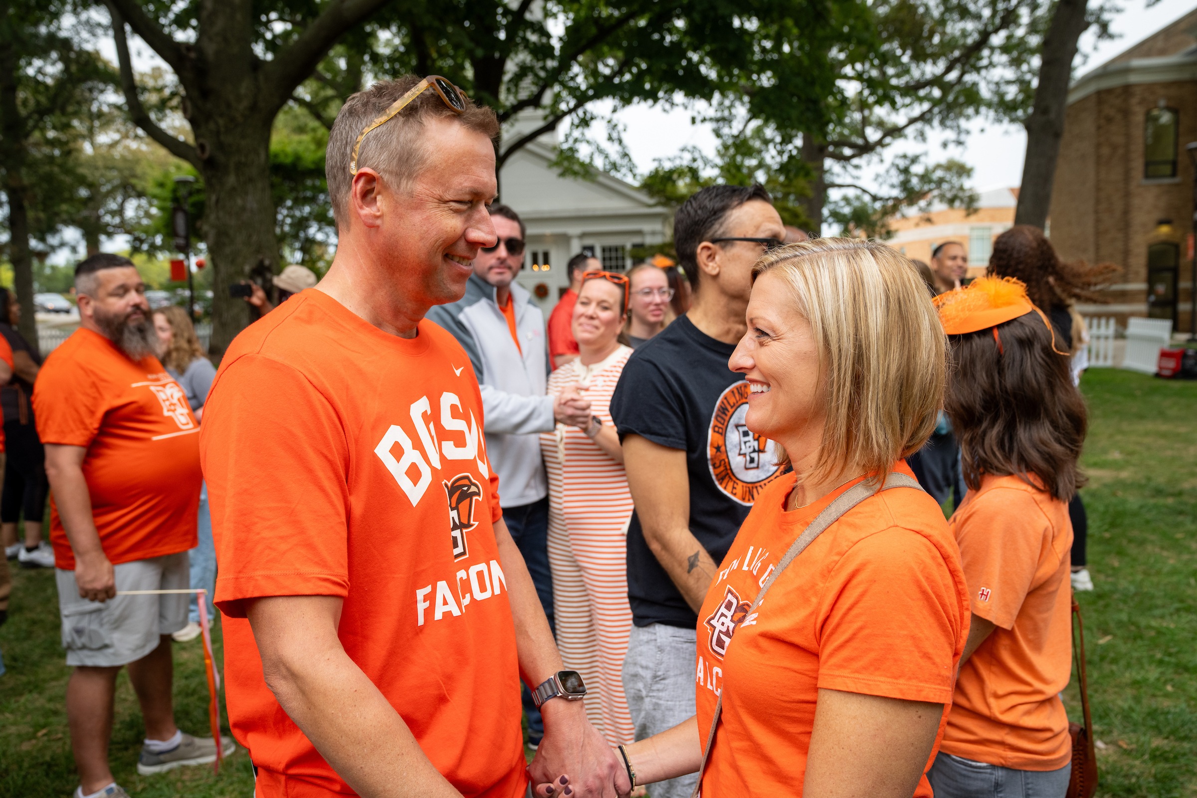 Two people hold hands during a vow renewal ceremony