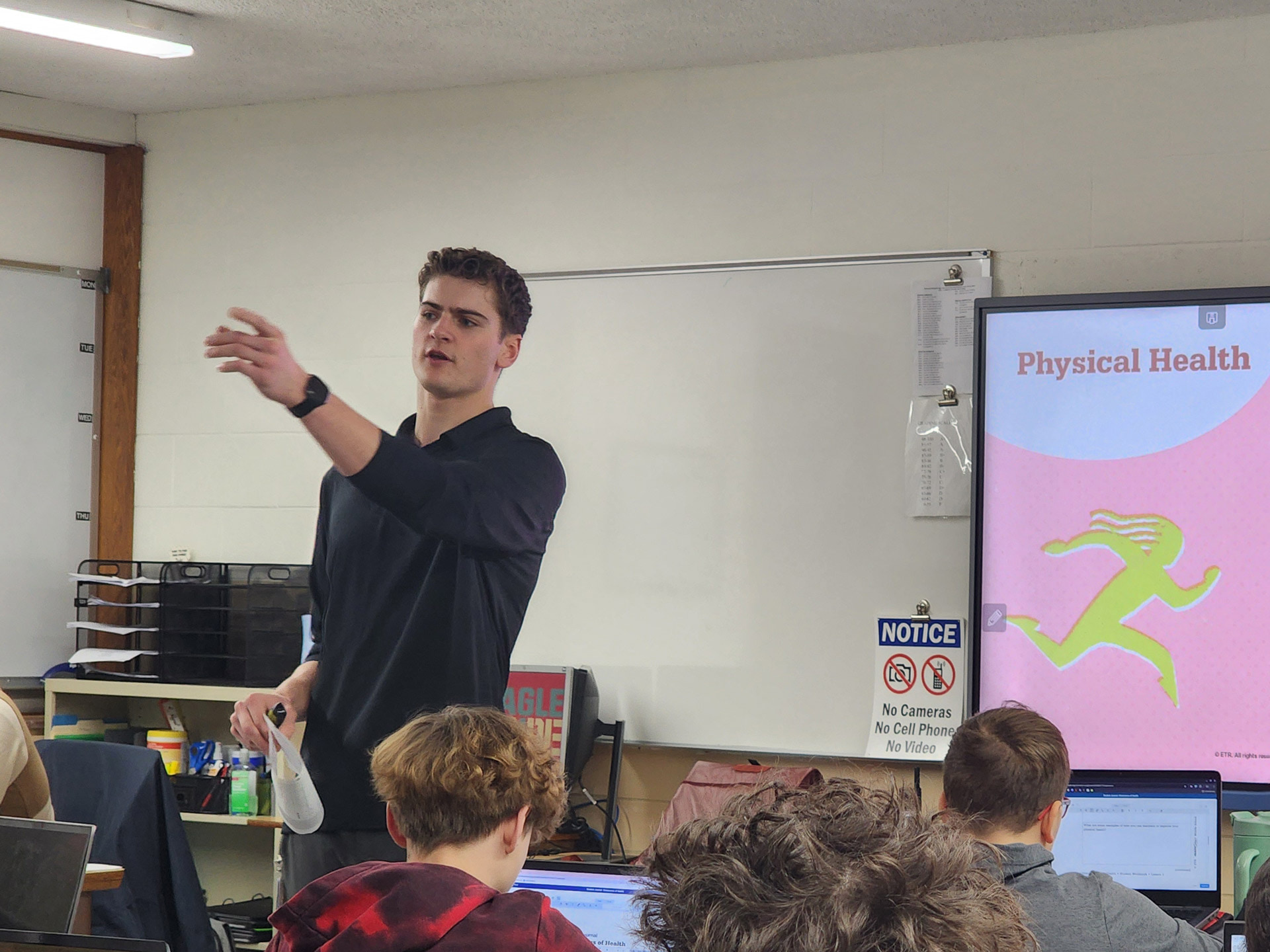 A teacher presenting in a classroom.