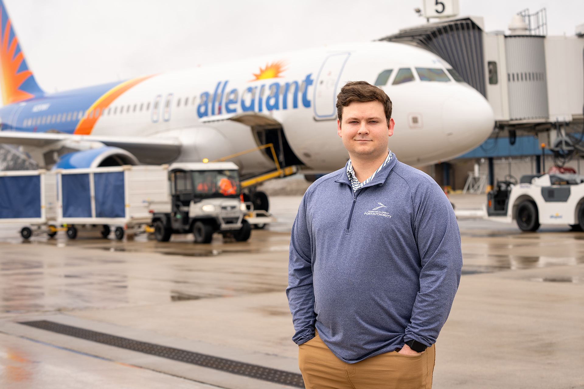 BGSU aviation management and operations student John Michael Schmitz stands in front of an airplane at Toledo Express Airport
