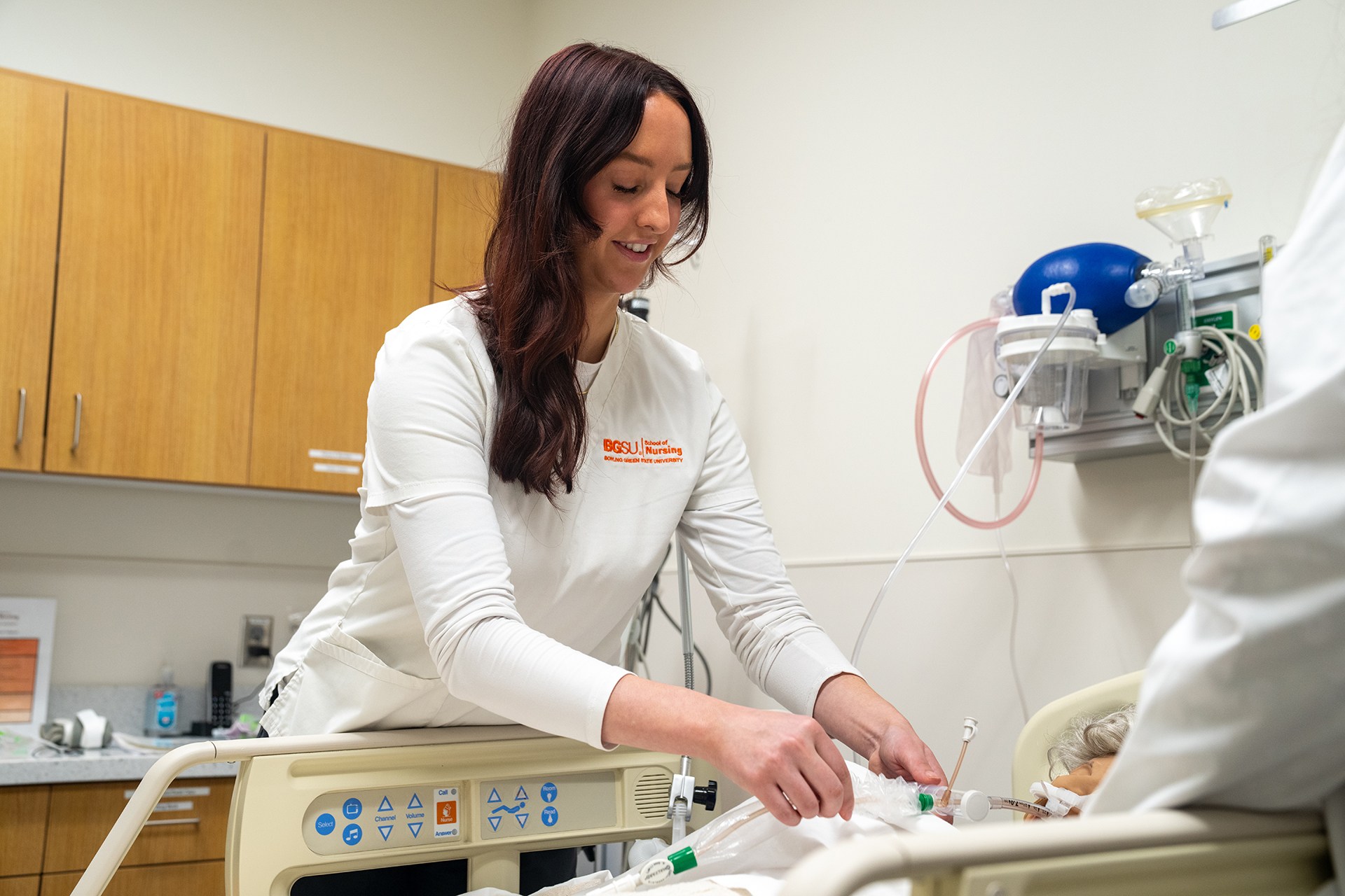 A nursing student training in a simulation lab.
