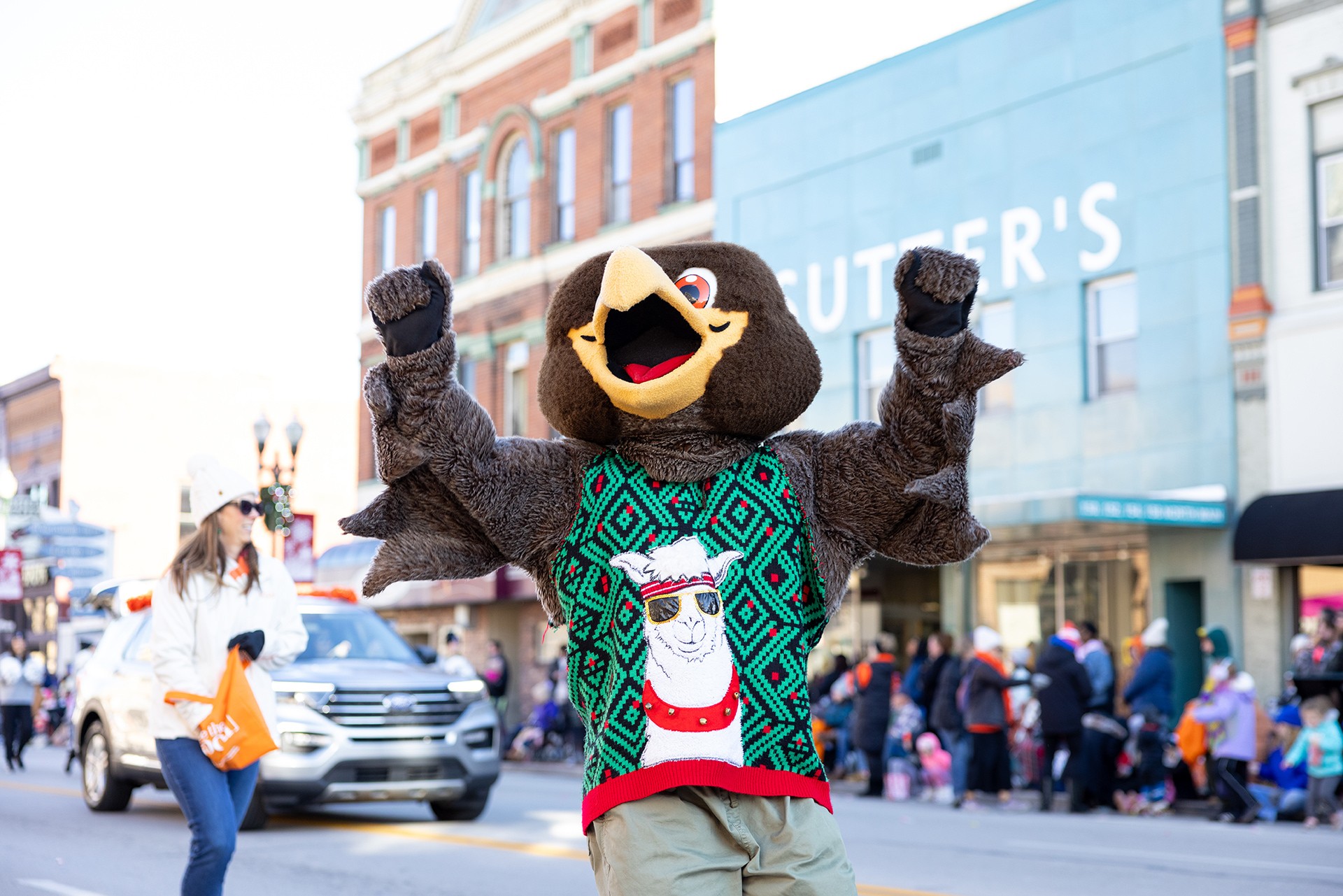 A mascot walks down Bowling Green Main Street during holiday parade