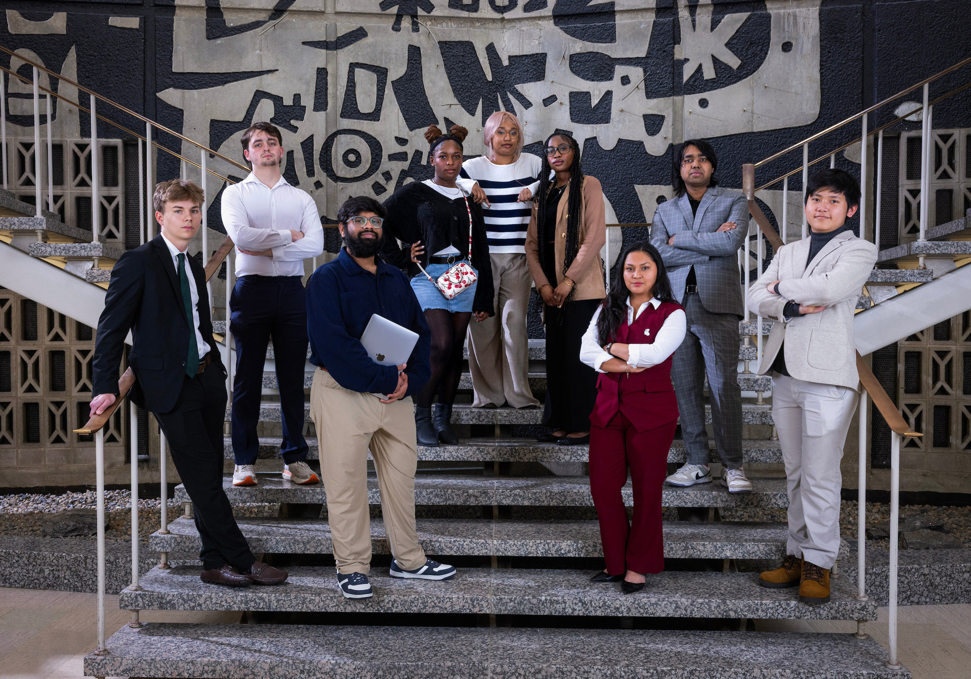 A photo of people standing on stairs for a picture.