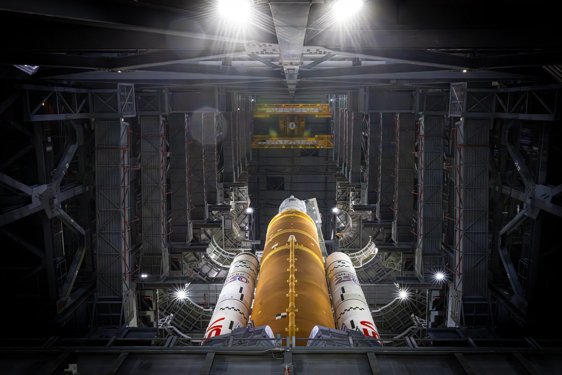 A space shuttle is shown from ground level at night.